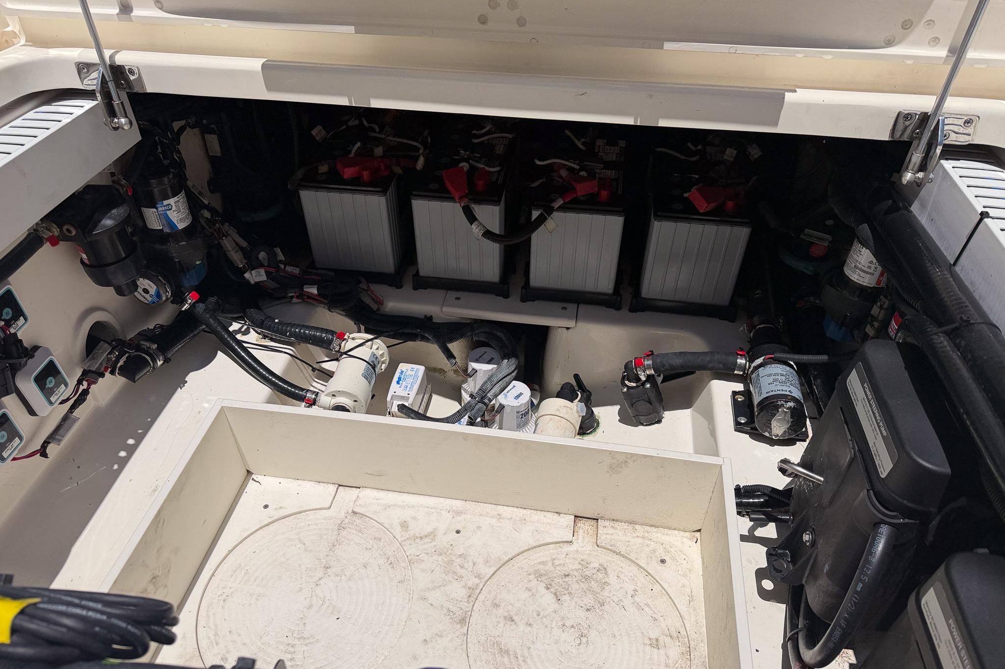 2021 Boston Whaler 330 Outrage engine compartment with batteries and wiring.