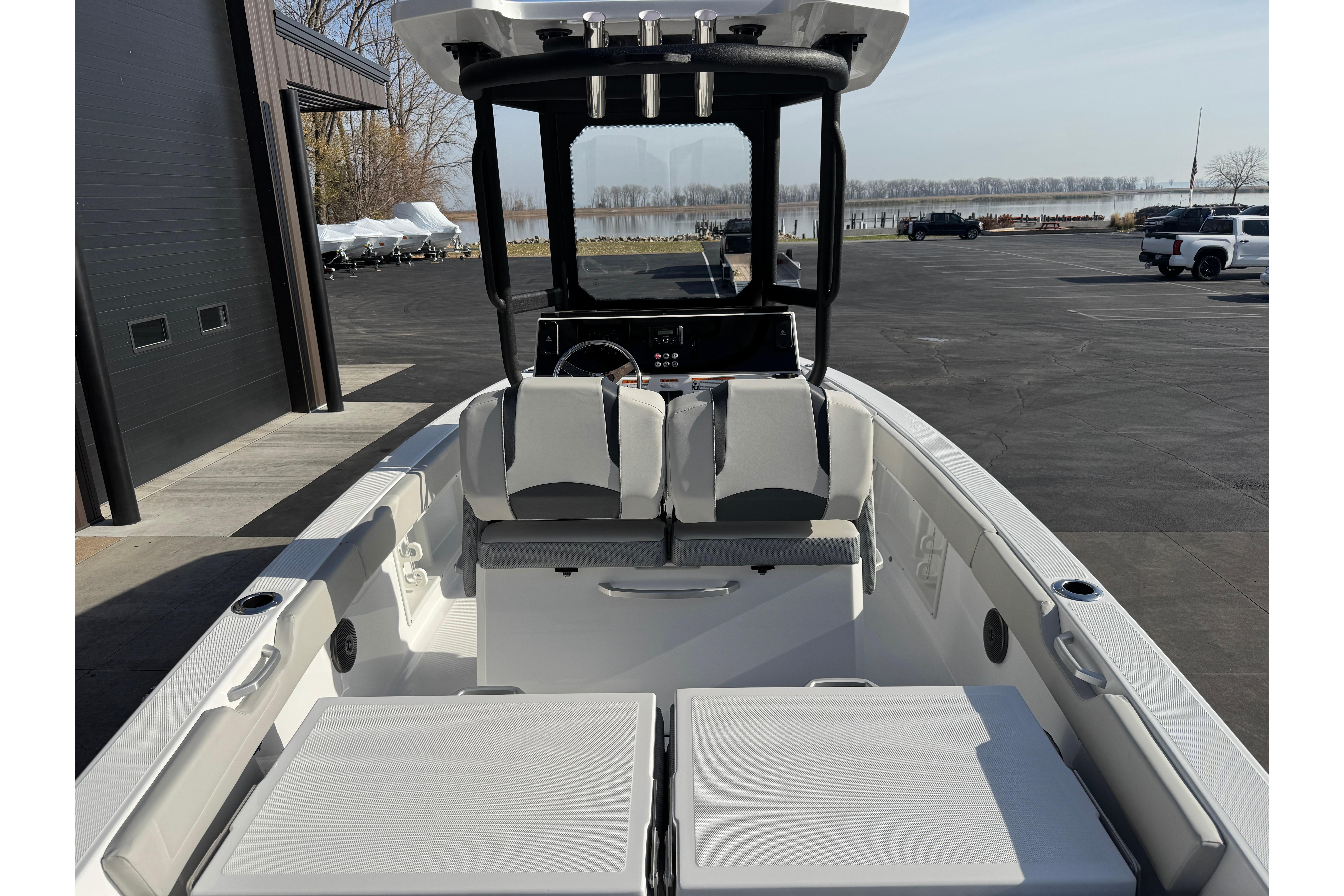 2026 Scarab 235 Open SE boat interior with seating and console, docked outdoors.