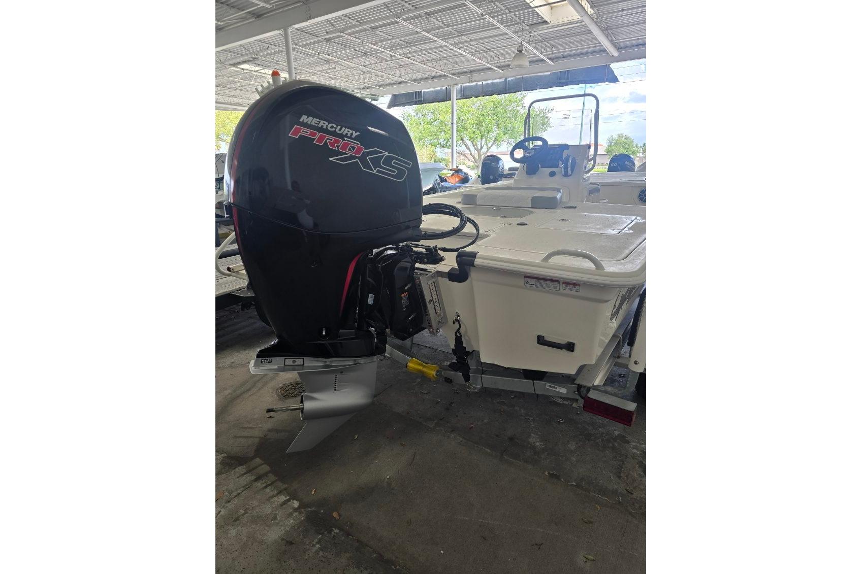 2026 Mako 18 Pro Skiff with Mercury Pro XS outboard motor in a covered area.