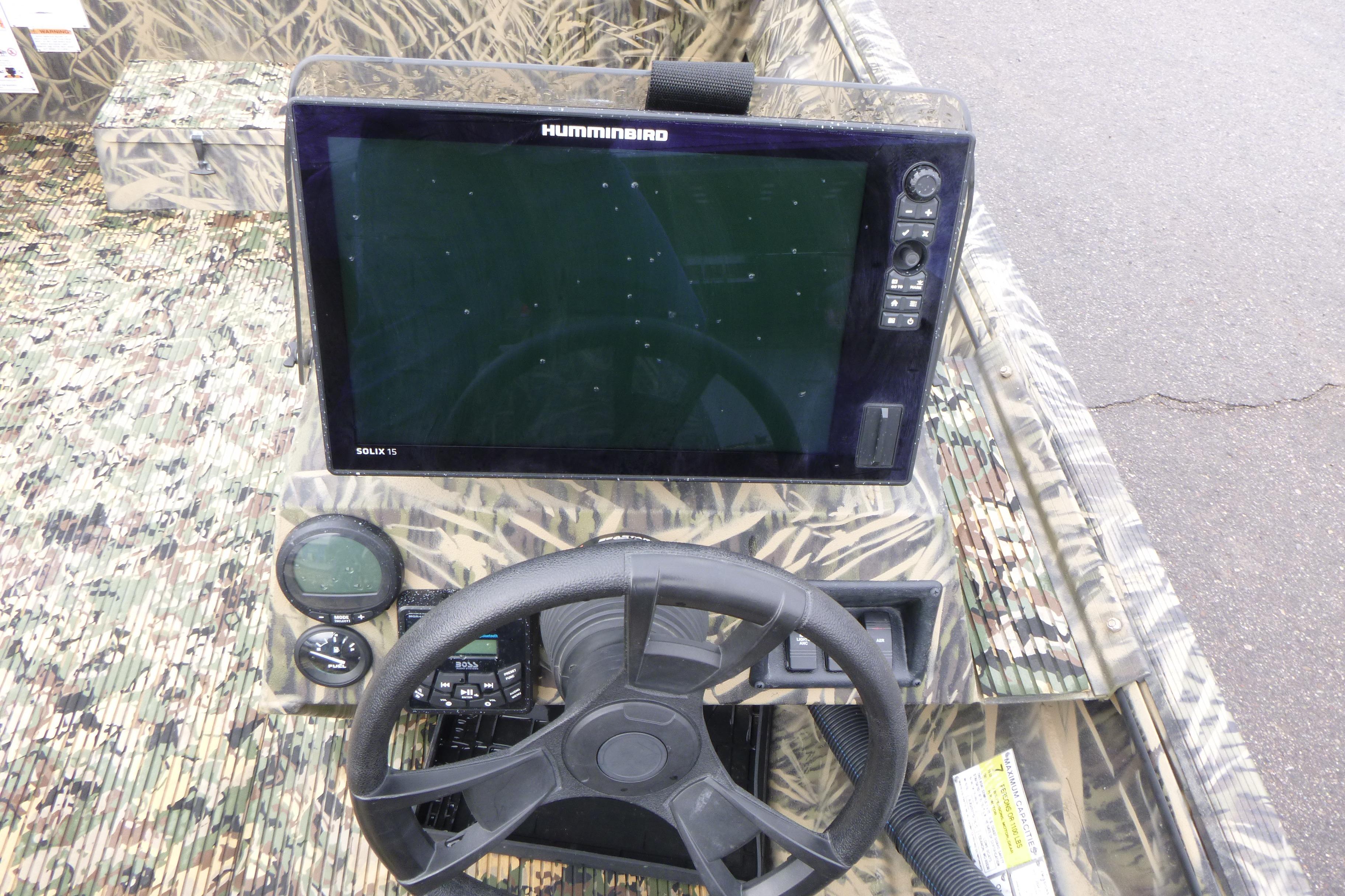 2024 Lowe Roughneck 2070 boat dashboard with Humminbird Solix 15 display and camo design.