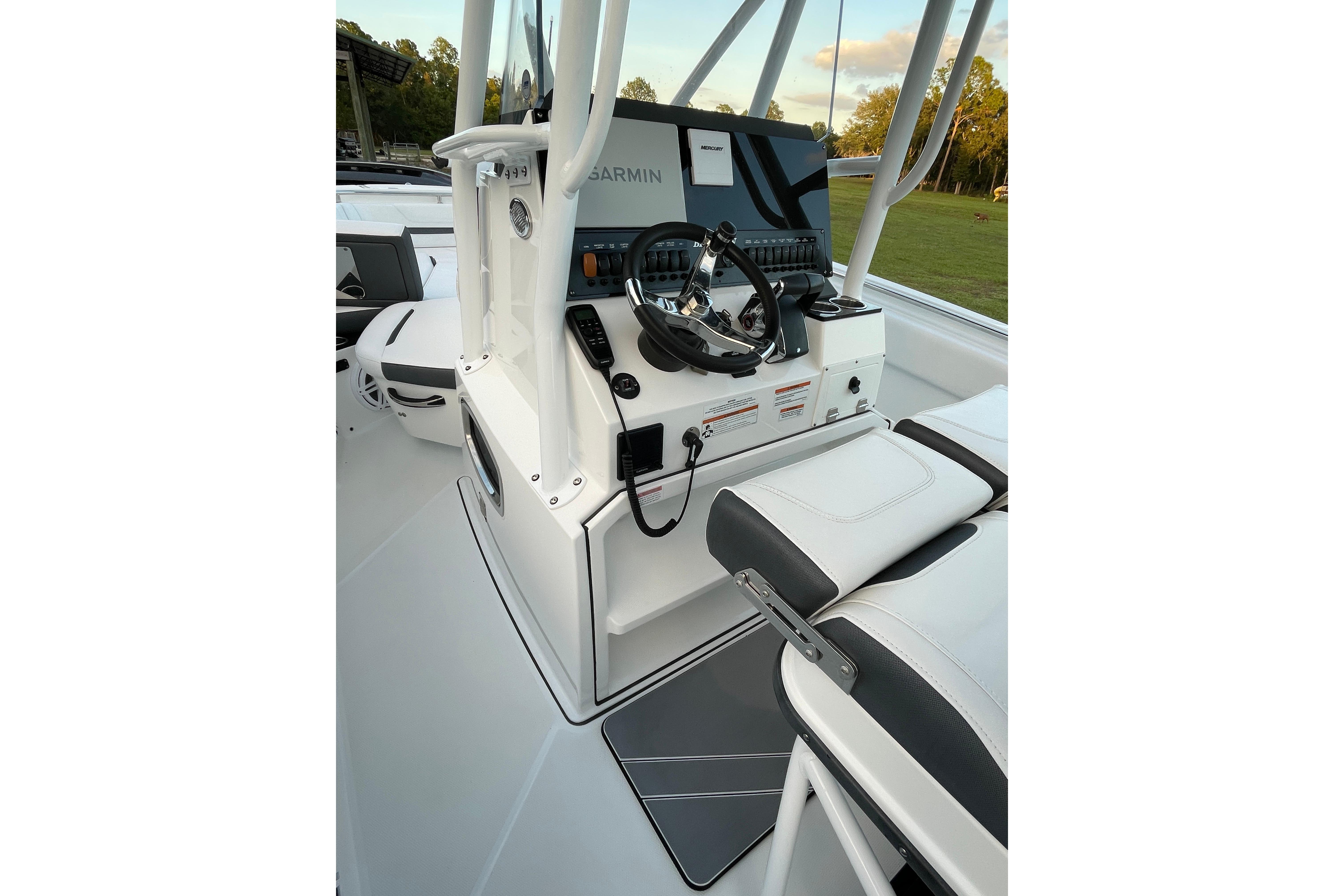 2022 Blackfin 252 CC boat console with Garmin navigation system and seating.