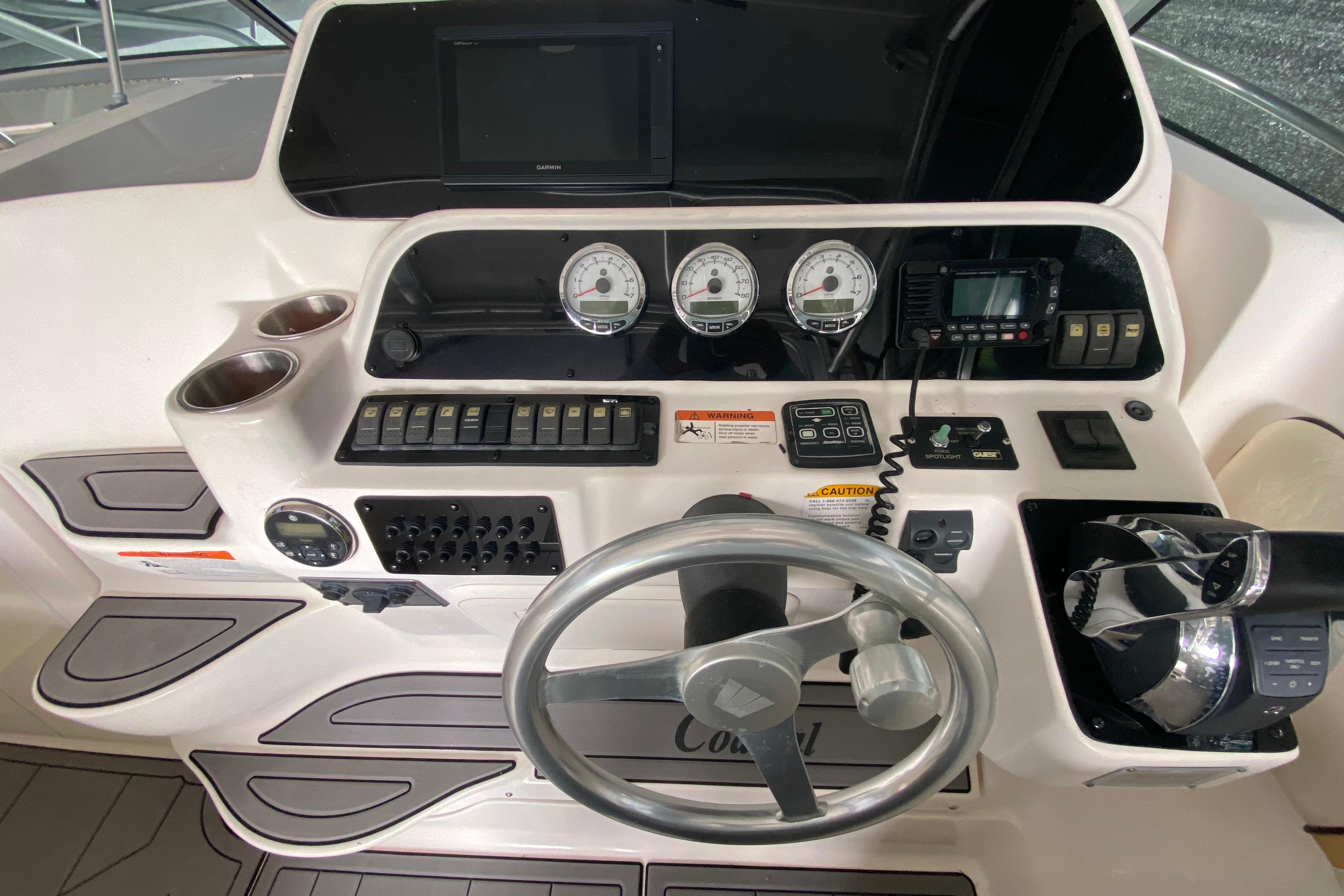 2005 Wellcraft 290 Coastal boat dashboard with steering wheel and control panel.