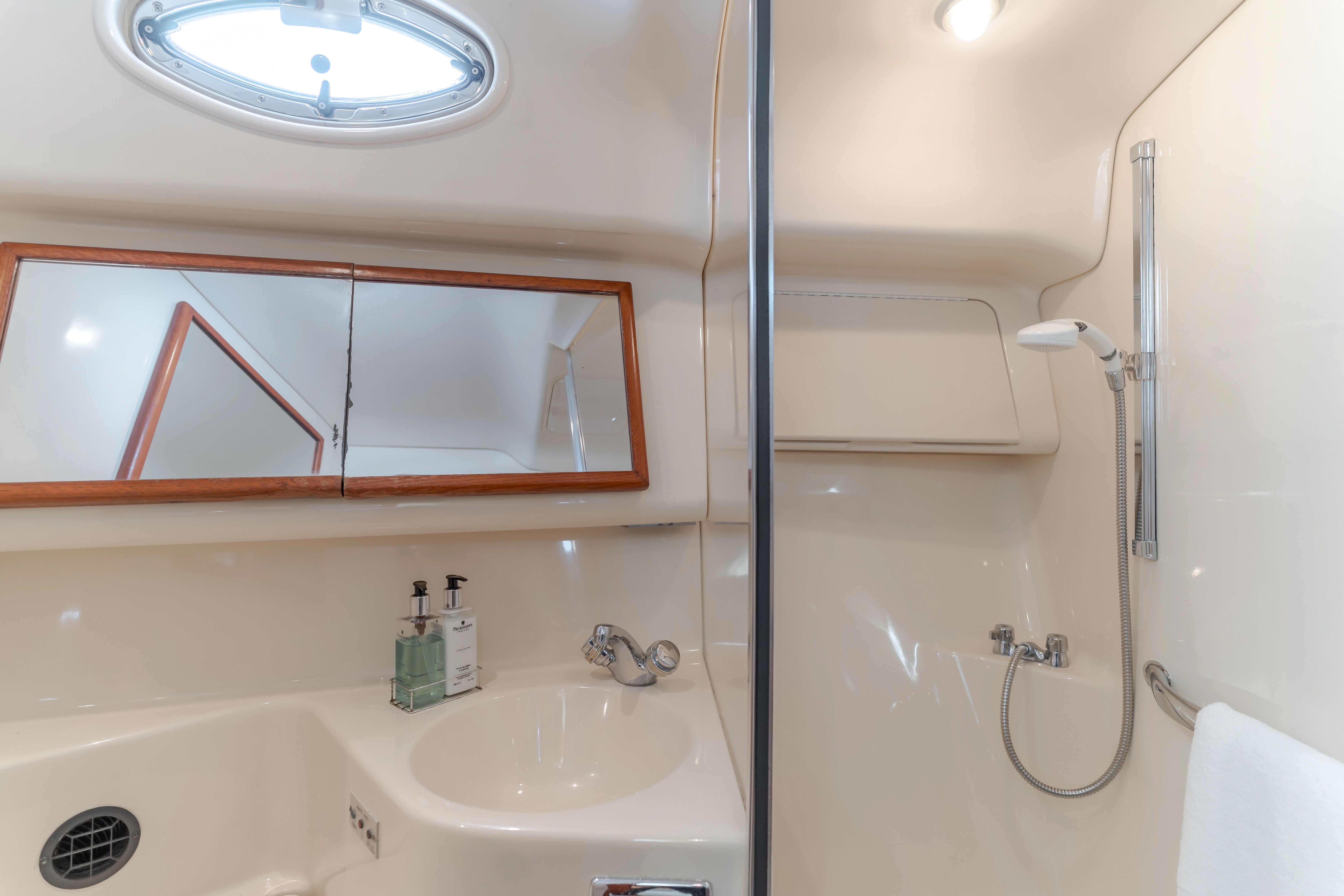 Sea Ray 400 Sedan Bridge 2002 bathroom with shower and mirror.