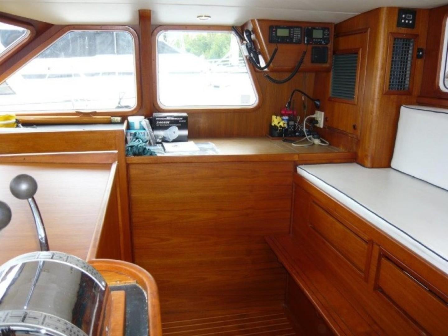 Interior of 1990 Cheoy Lee Sloop with wooden finish and navigation equipment.