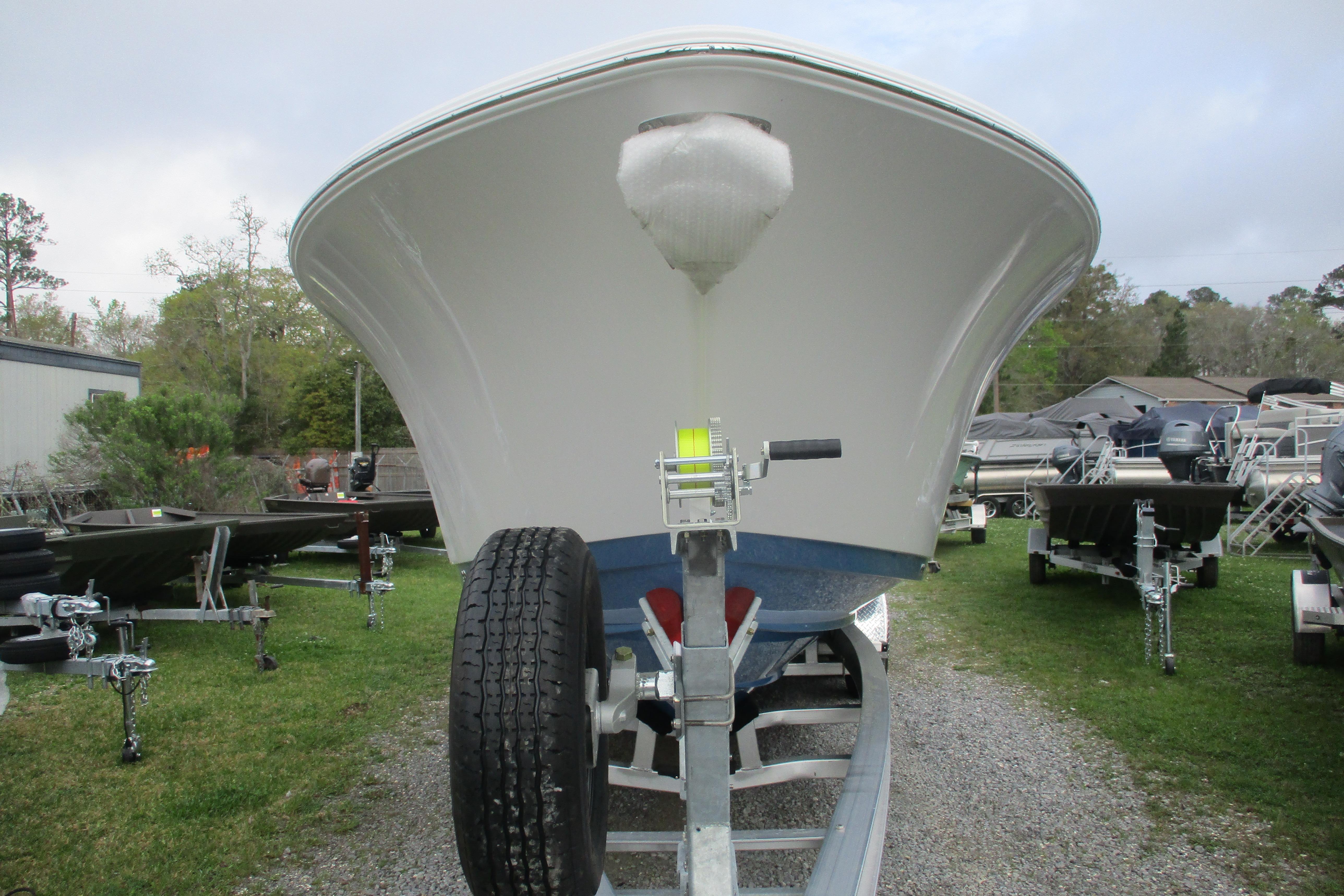 2026 Sportsman Open 302 Center Console boat on trailer, front view, outdoors.