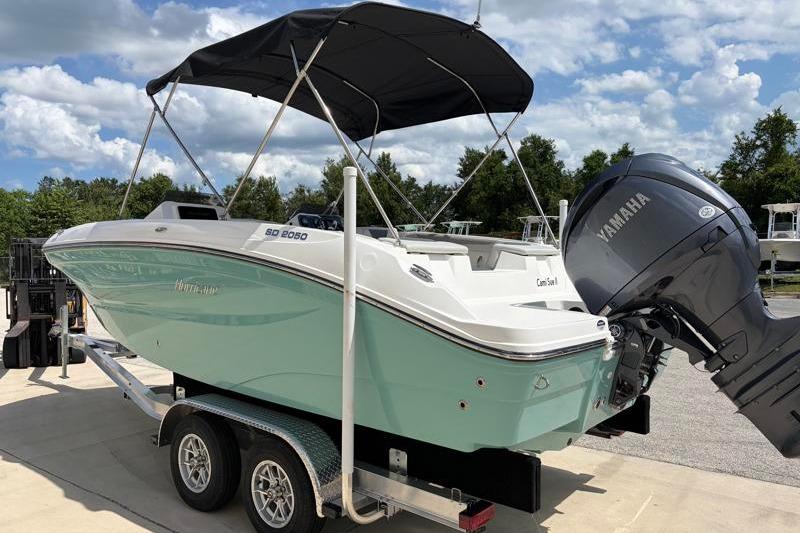 2026 Hurricane SunDeck Sport 2050 OB boat on trailer with Yamaha outboard motor.