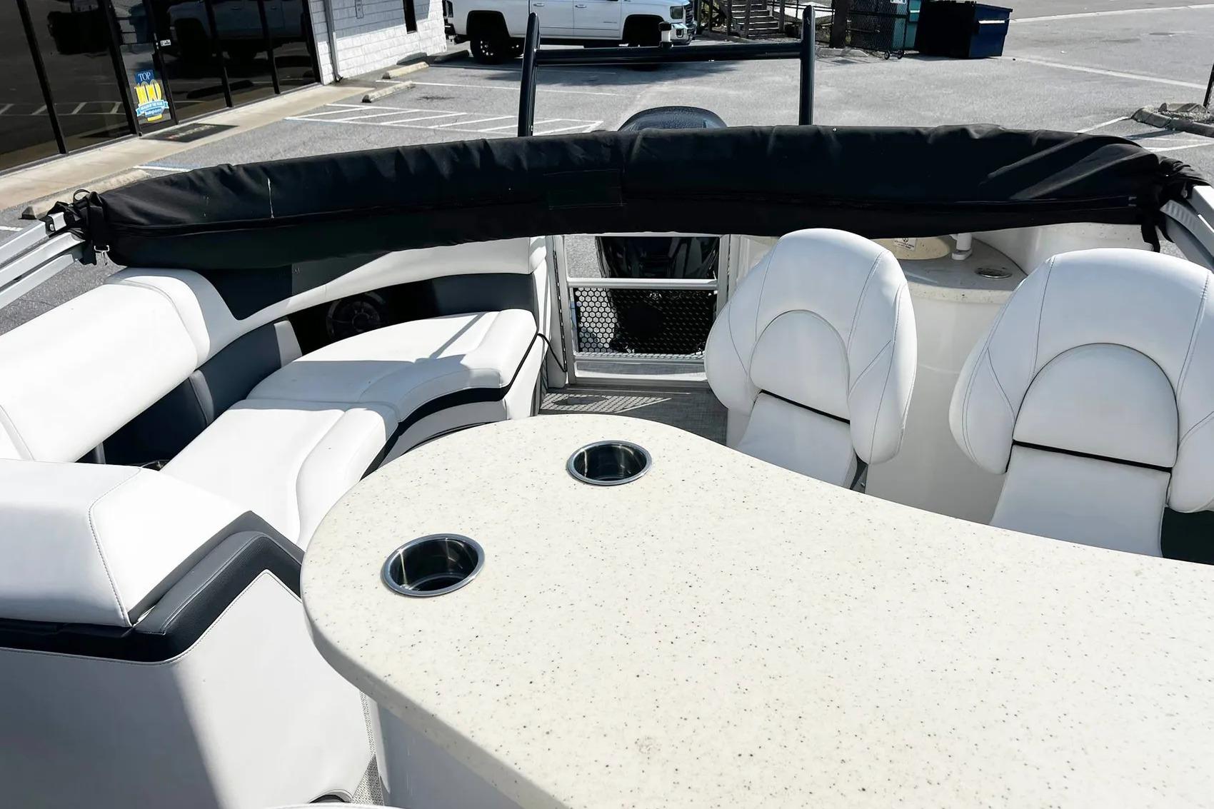 Interior of 2023 South Bay 523 R boat with white seating and table.