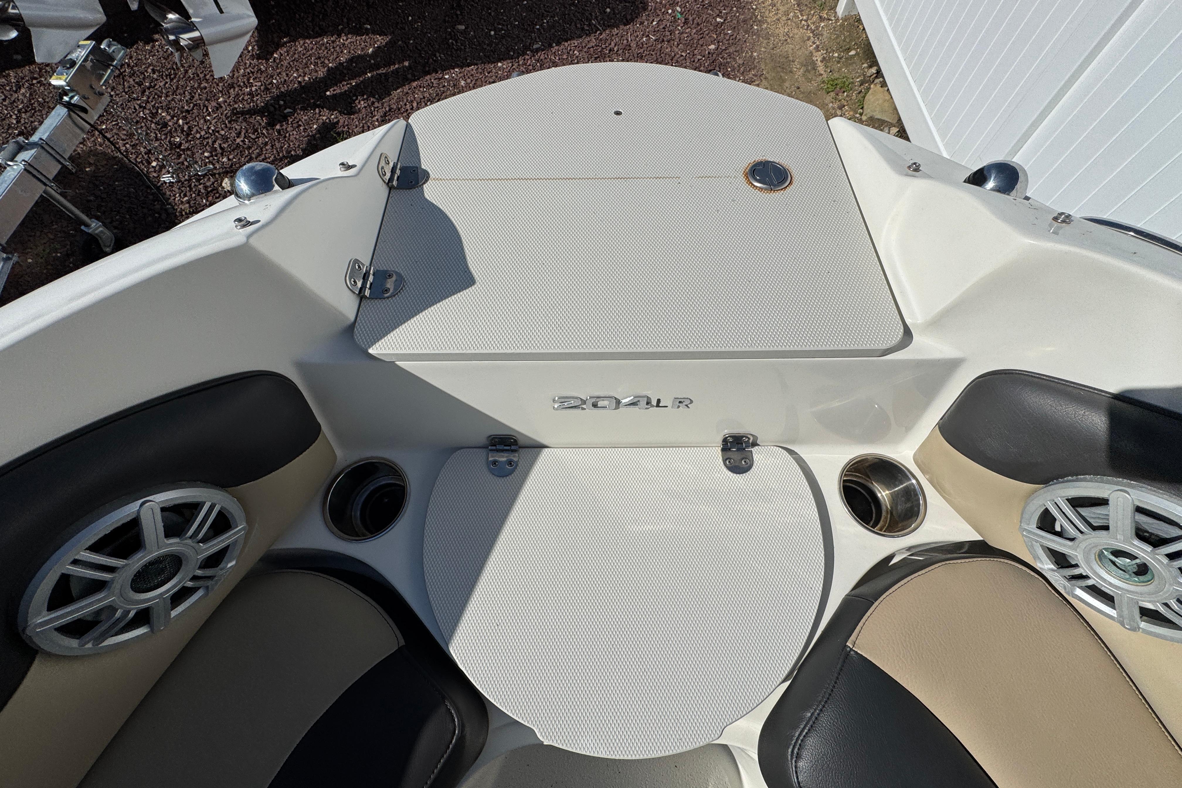 Interior of a 2018 Stingray 204 LR boat, featuring seating and speakers.