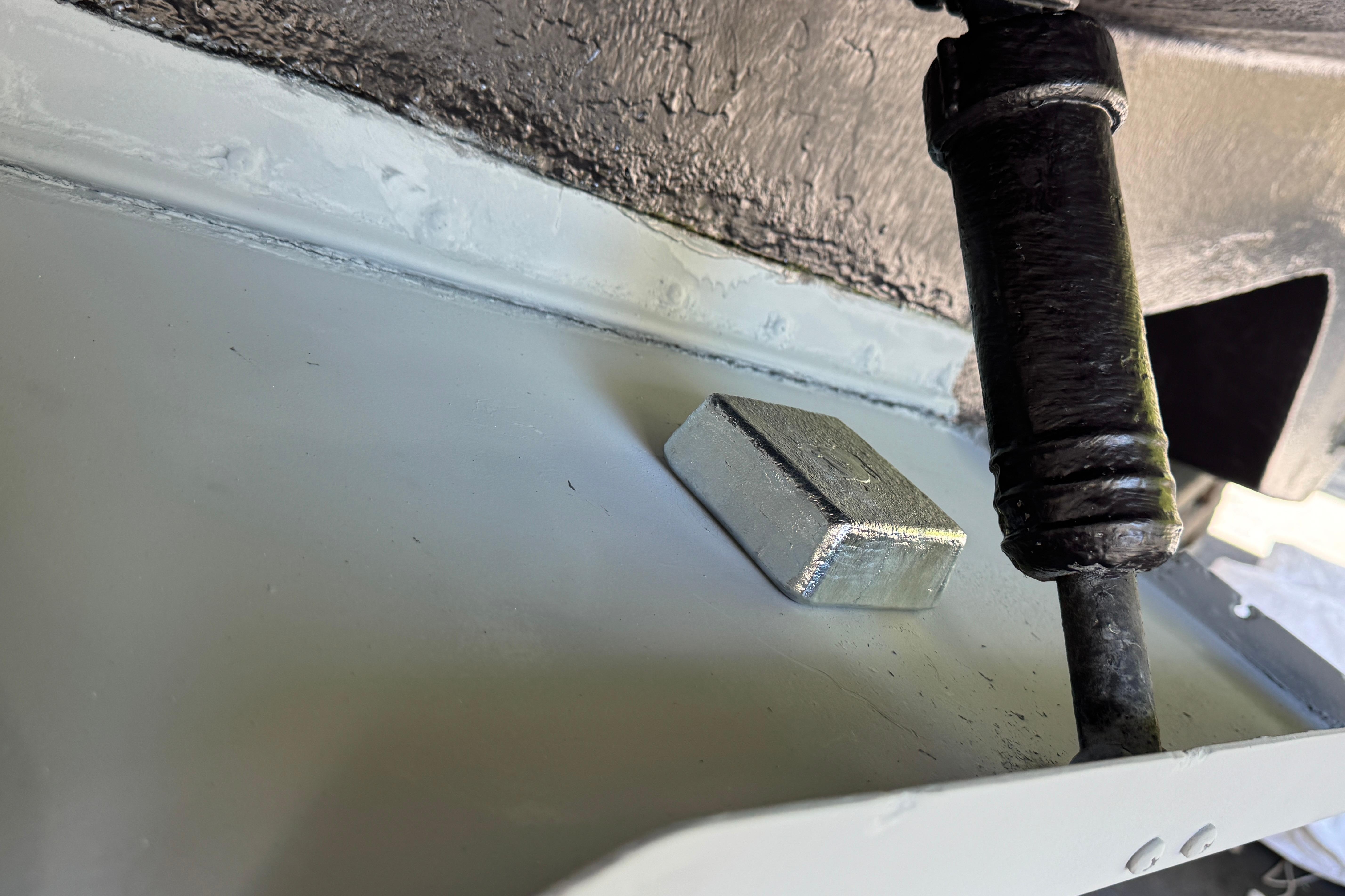 Close-up of a 2000 Sea Ray 380 Aft Cabin boat component with metal block.