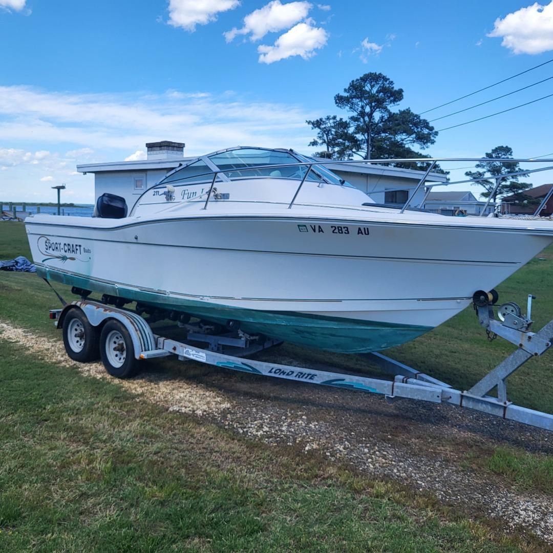 1998 Sport-Craft 211WAC on a trailer on grass, with a blue sky in the background.