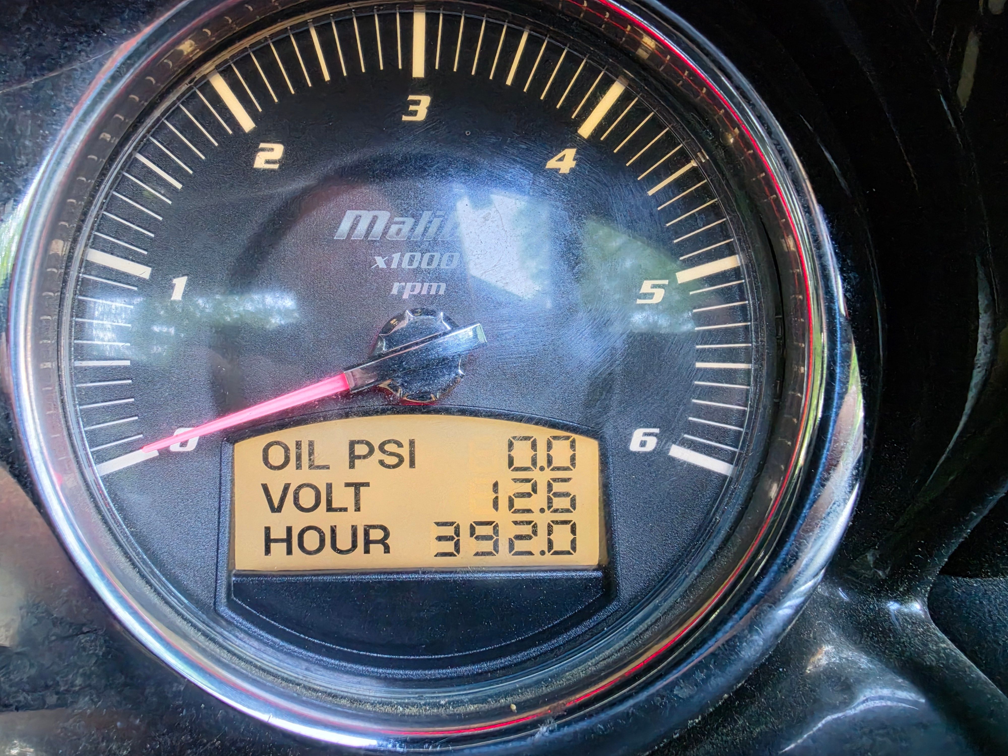 2014 Malibu Wakesetter 24 MXZ tachometer showing oil, voltage, and hours.