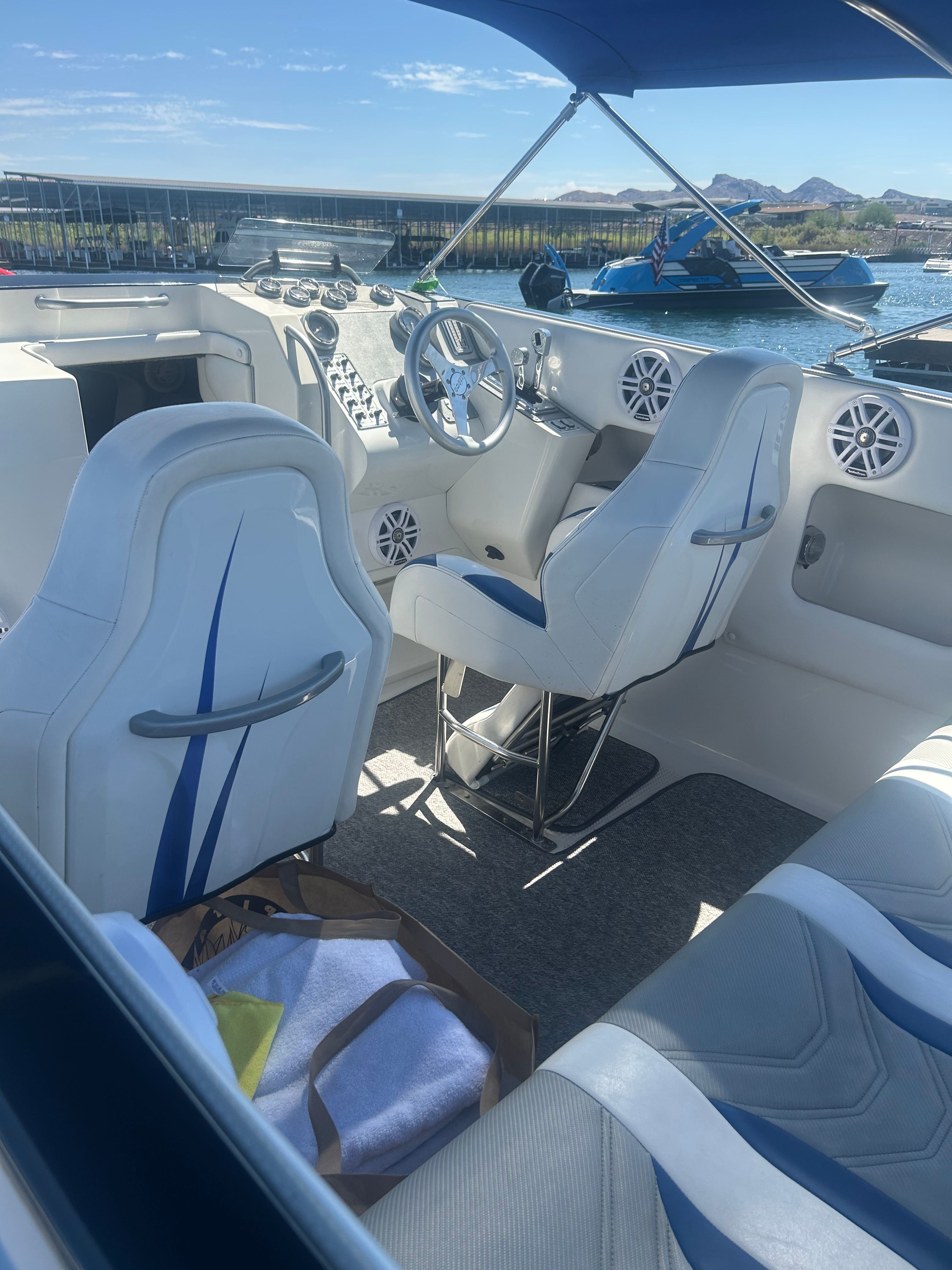 Interior of a 1999 Lavey Craft 2950 NuEra with white seats and blue accents.