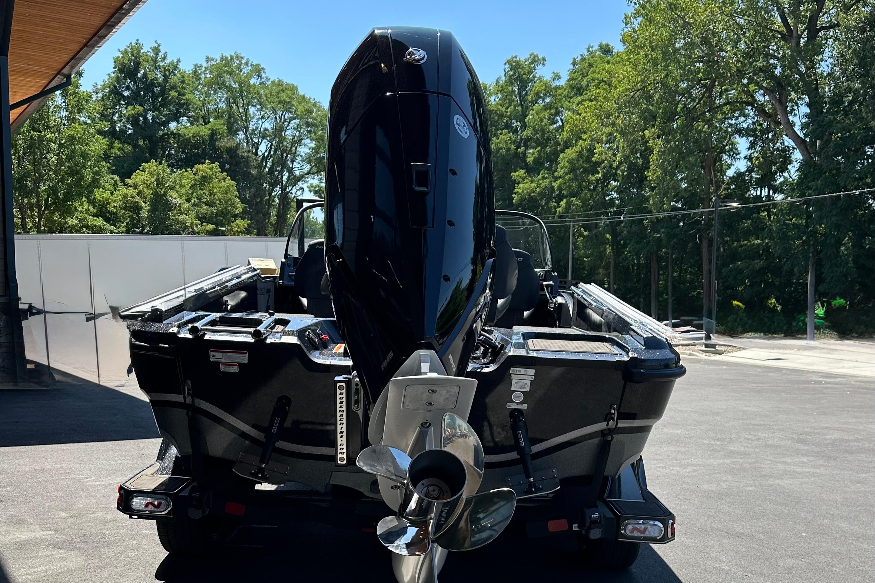 2025 Nitro ZV21 Pro boat with powerful outboard motor, parked outdoors.