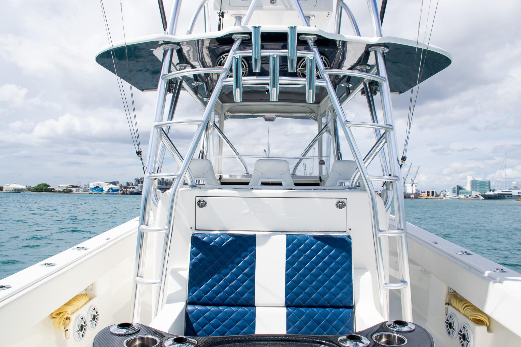 2022 SeaVee 390Z boat with blue seating, docked in a marina under cloudy skies.