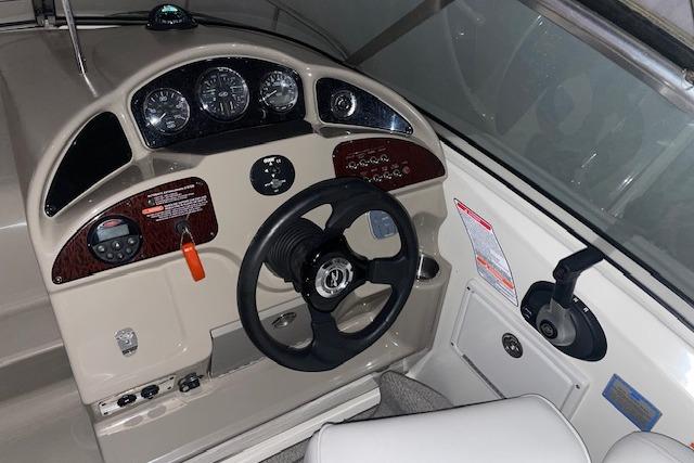 2006 Sea Ray Sundancer 260 helm with steering wheel, gauges, and controls.