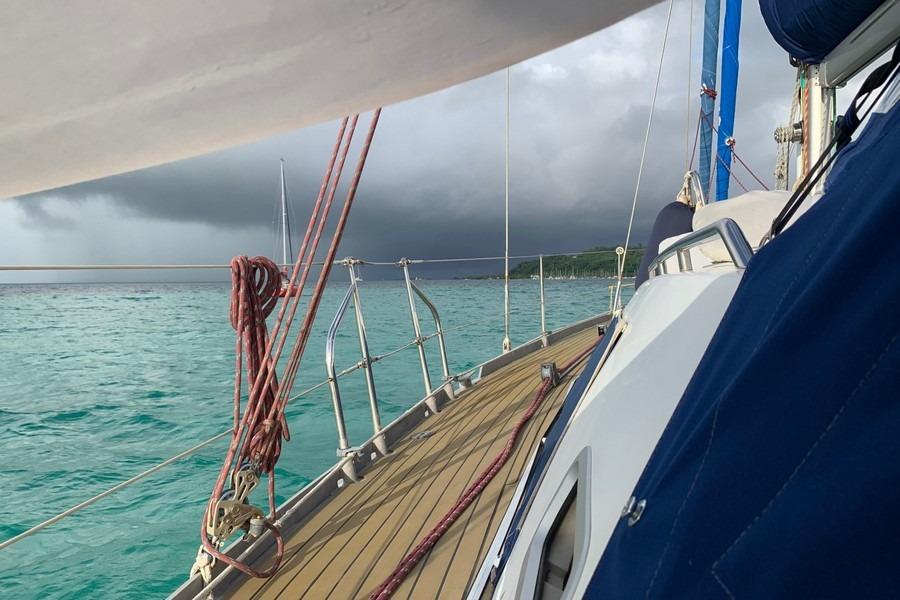 Sailing on Allures 44 yacht, 2010 model, with stormy skies and turquoise waters.