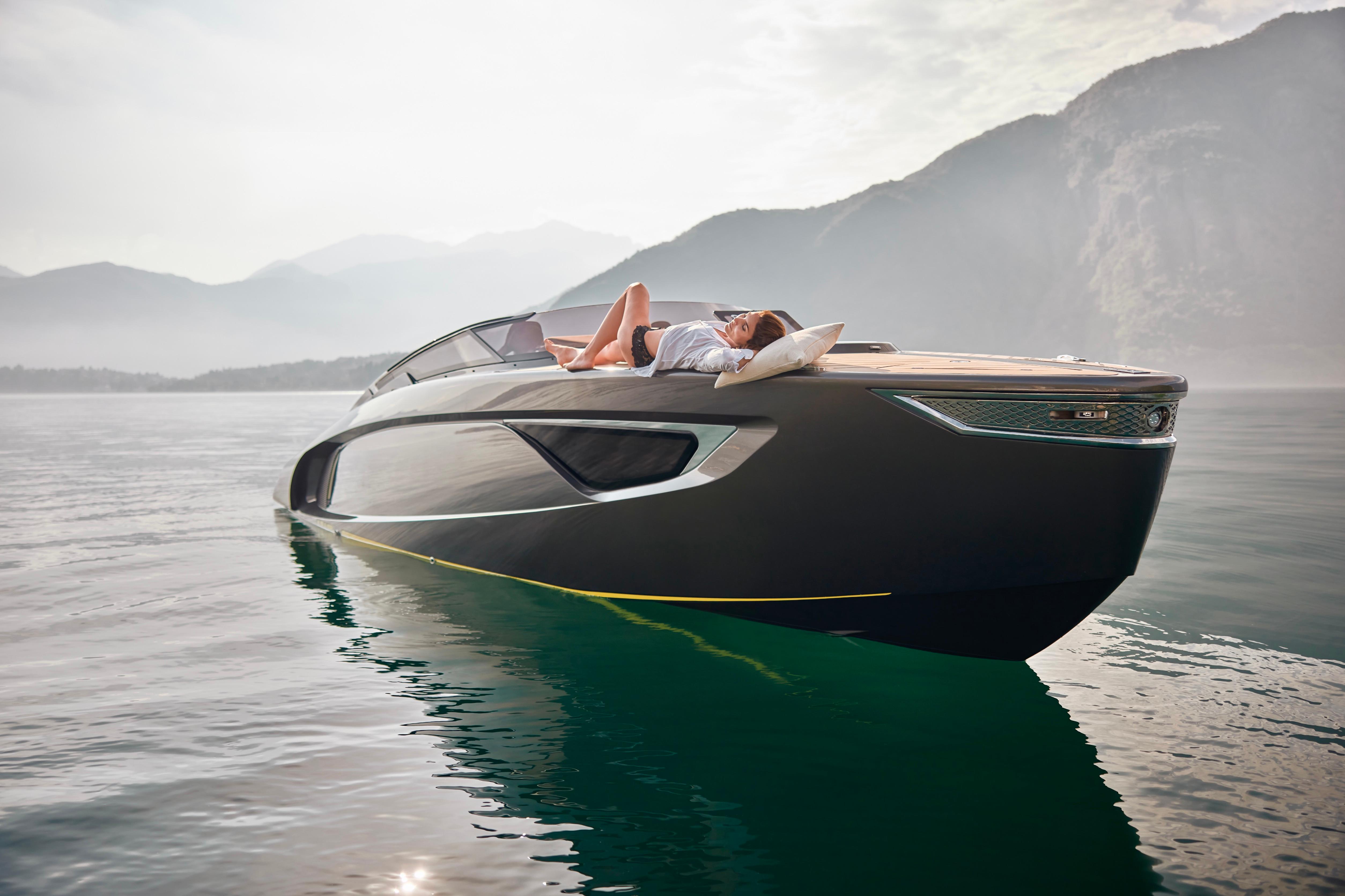 2026 Flynt Yachts Centura 32 on serene water, person relaxing on deck.