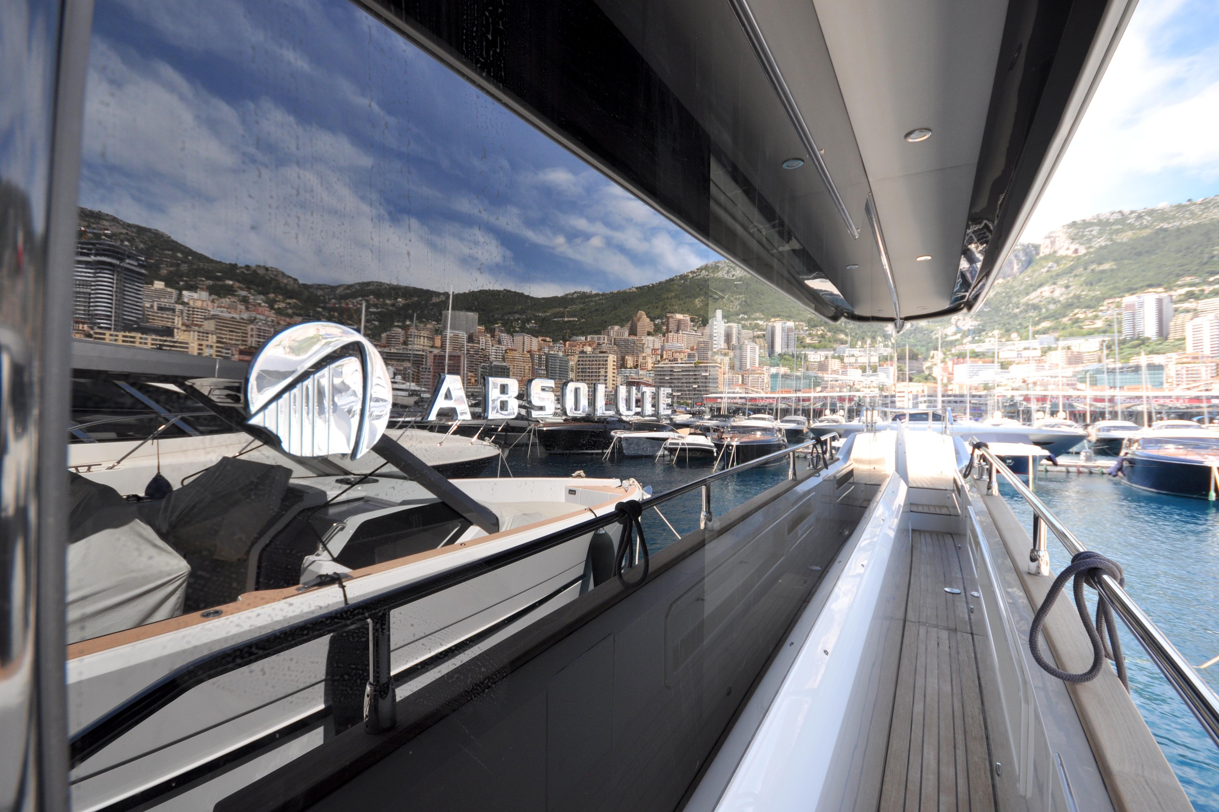 2018 Absolute Navetta 52 yacht docked in a scenic marina with city backdrop.