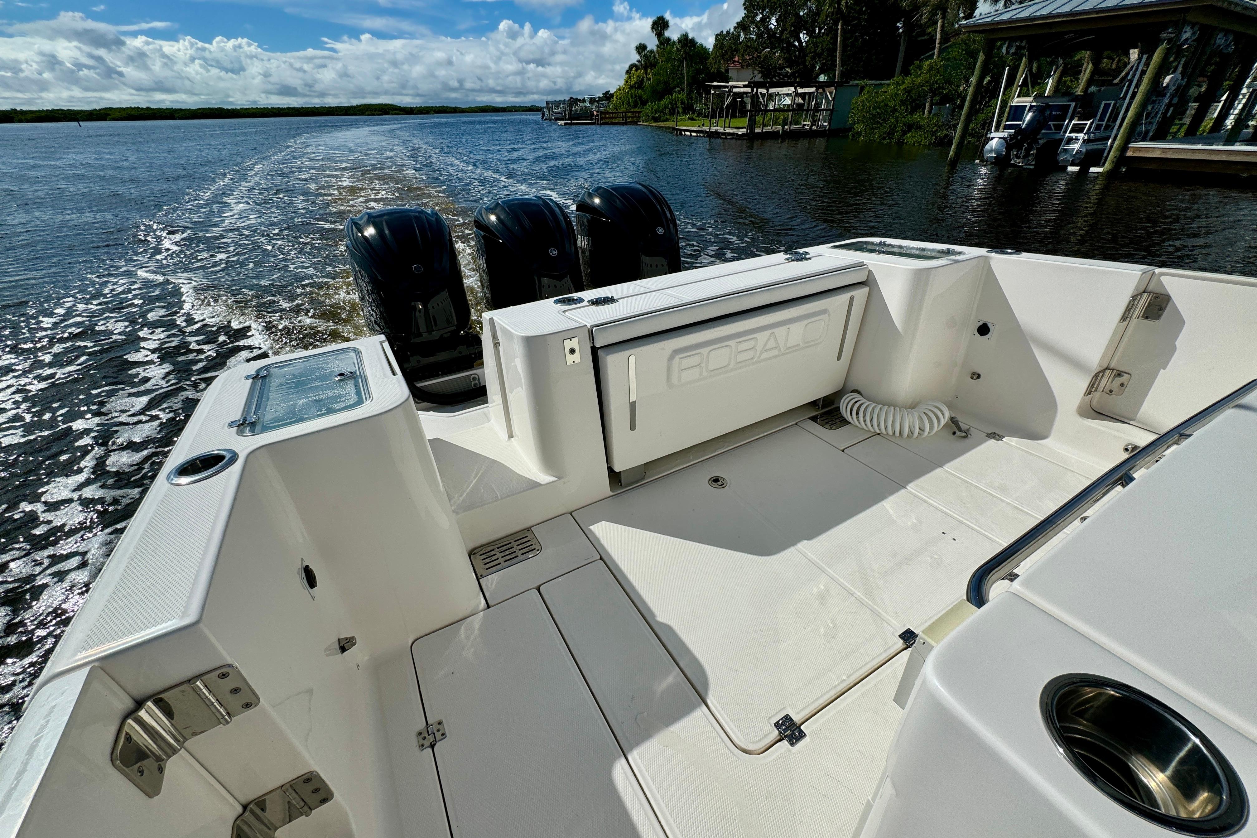 2022 Robalo R360 Center Console boat cruising on a scenic waterway.