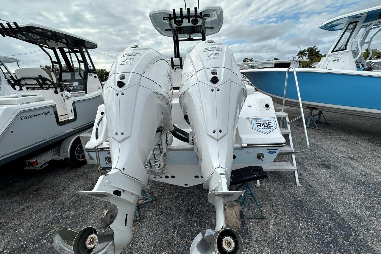 2026 Tidewater 272 LXF boat with dual outboard engines, parked on a trailer.