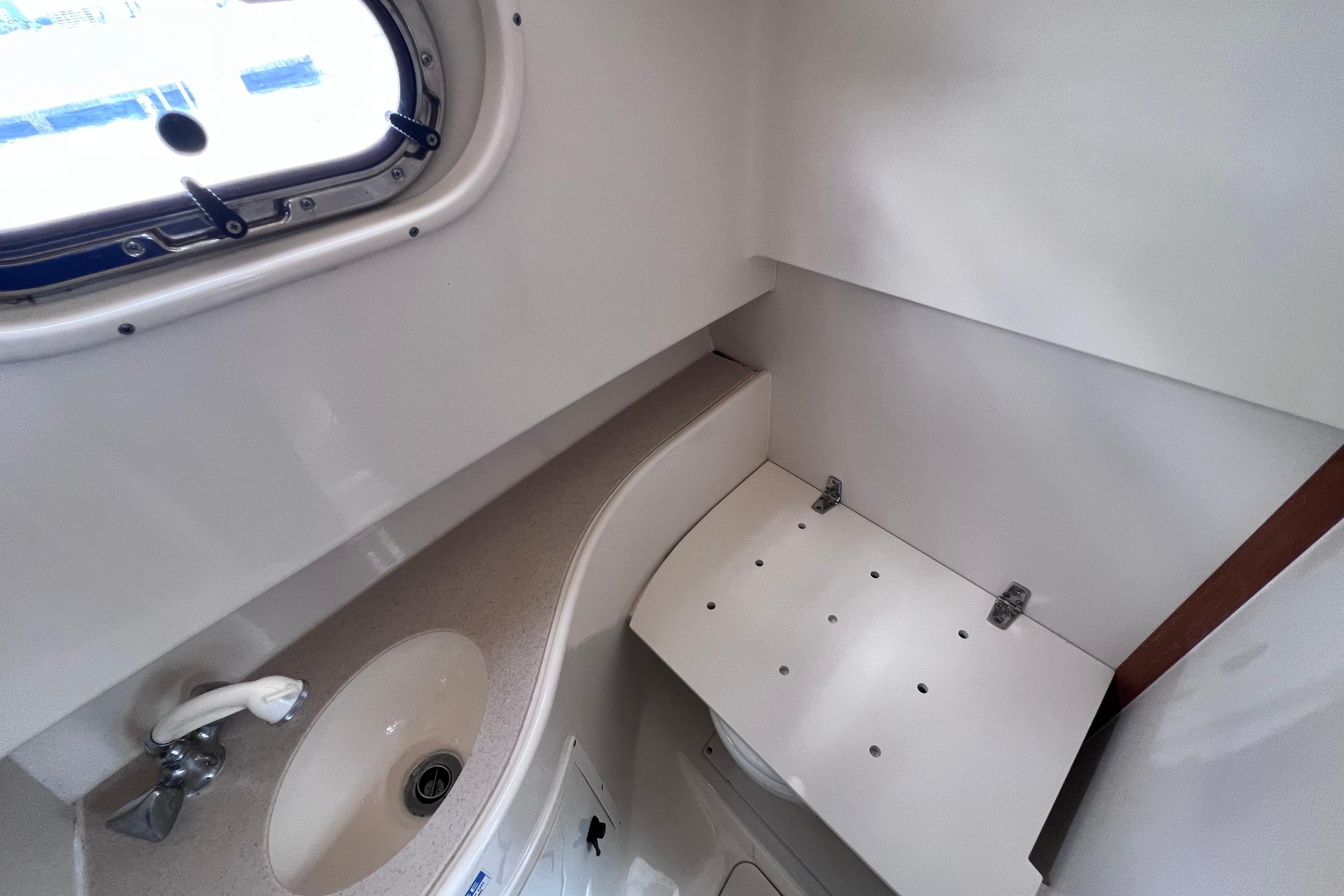 2004 Pursuit 2870 Walkaround boat interior with sink and window.