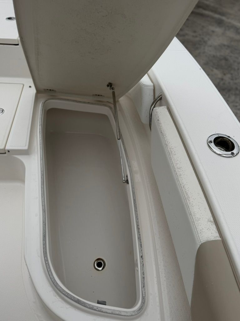 Open storage compartment on a 2018 Robalo 246 Cayman SD boat.