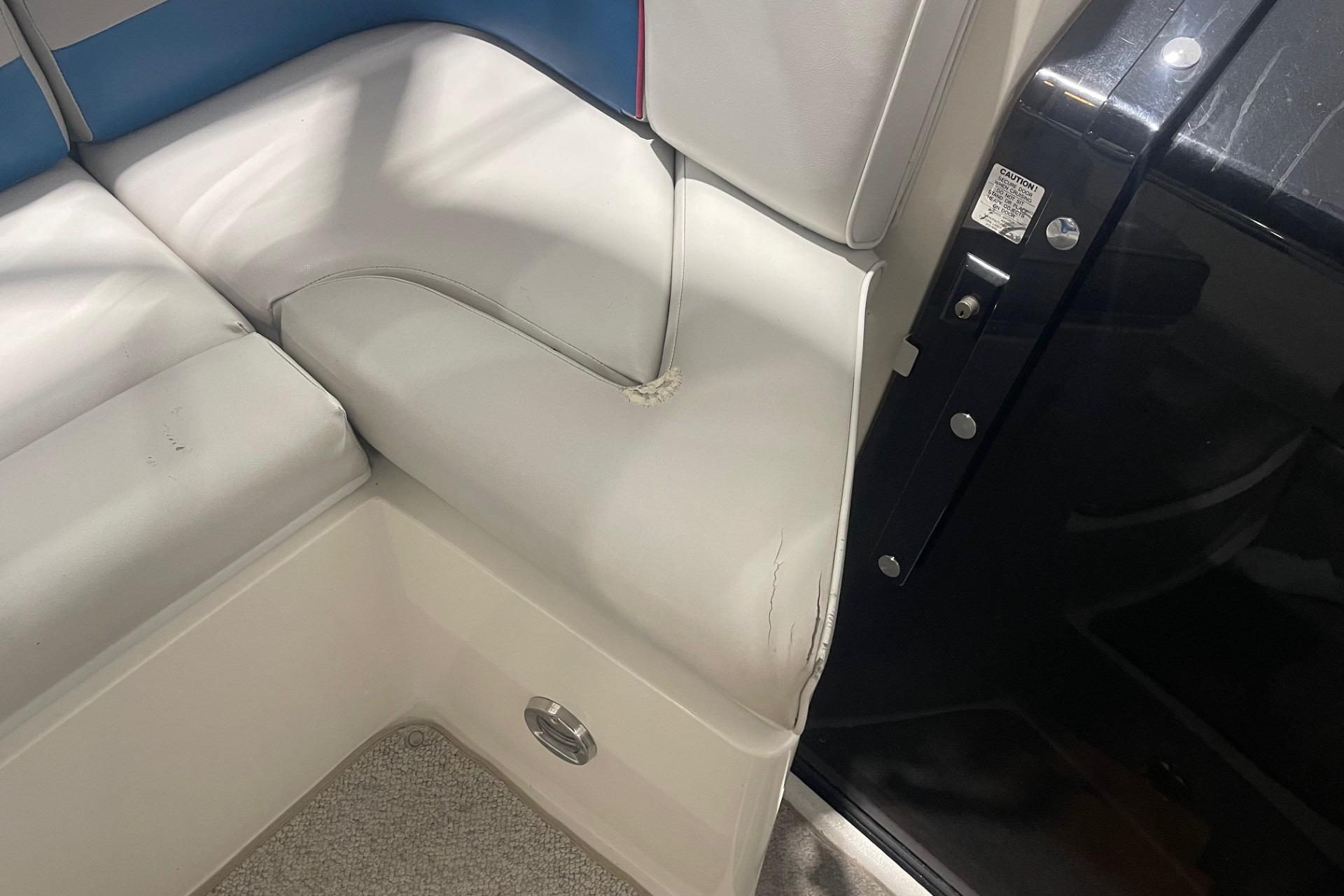 1992 Chaparral Signature 30 boat interior with white and blue seating, showing wear.