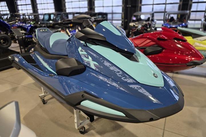 2026 Yamaha WaveRunner VX Cruiser in showroom, sleek blue design, modern watercraft display.