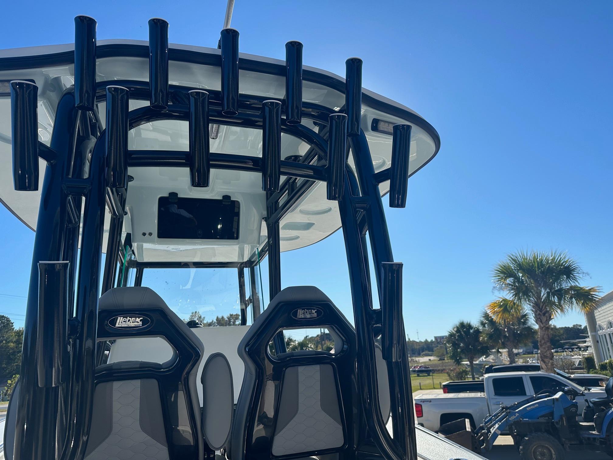2025 Cape Horn 28XS boat with rod holders and seating, under clear blue sky.