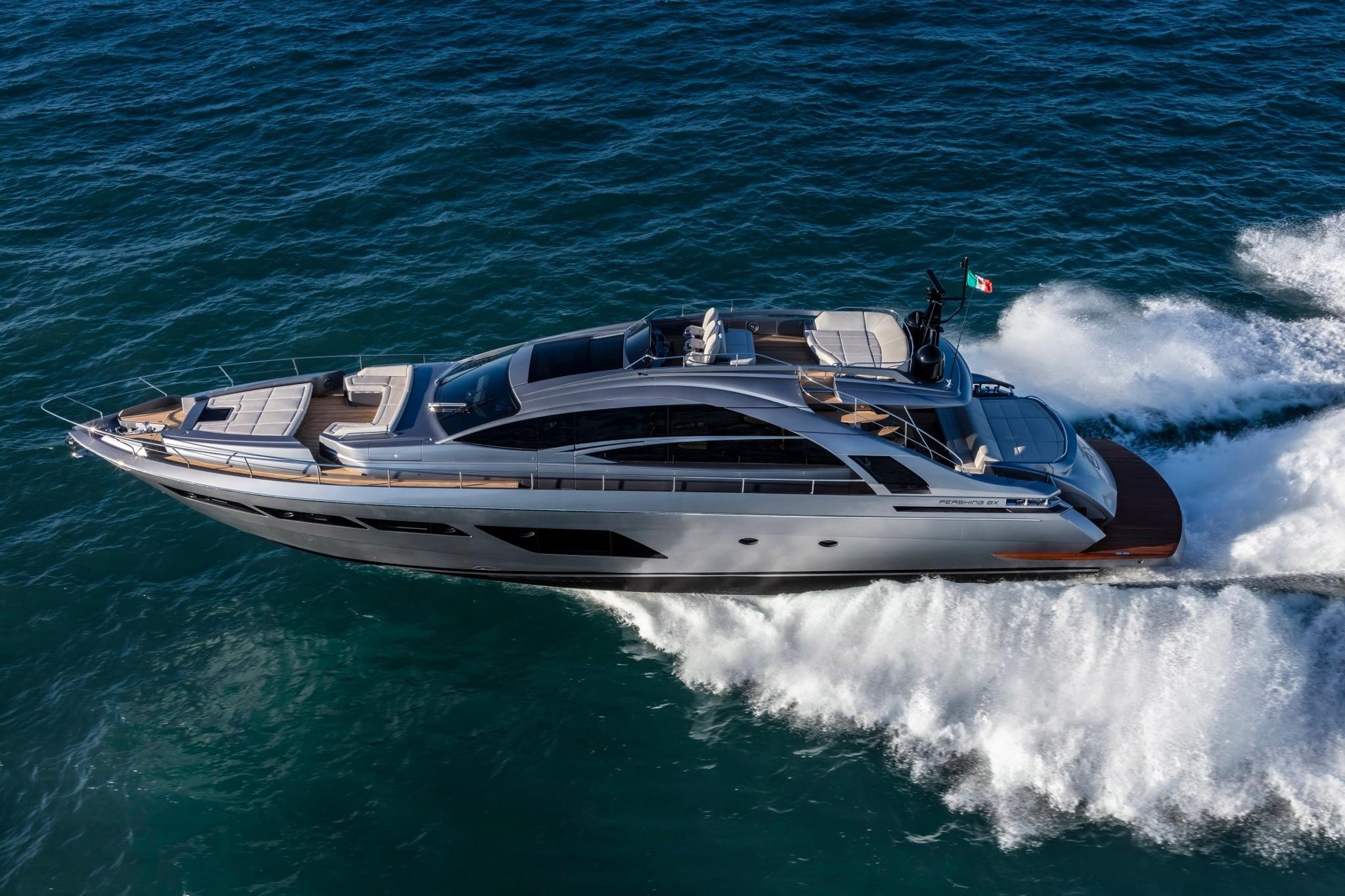 Luxurious 2020 Pershing 8X yacht cruising swiftly on open sea waters.