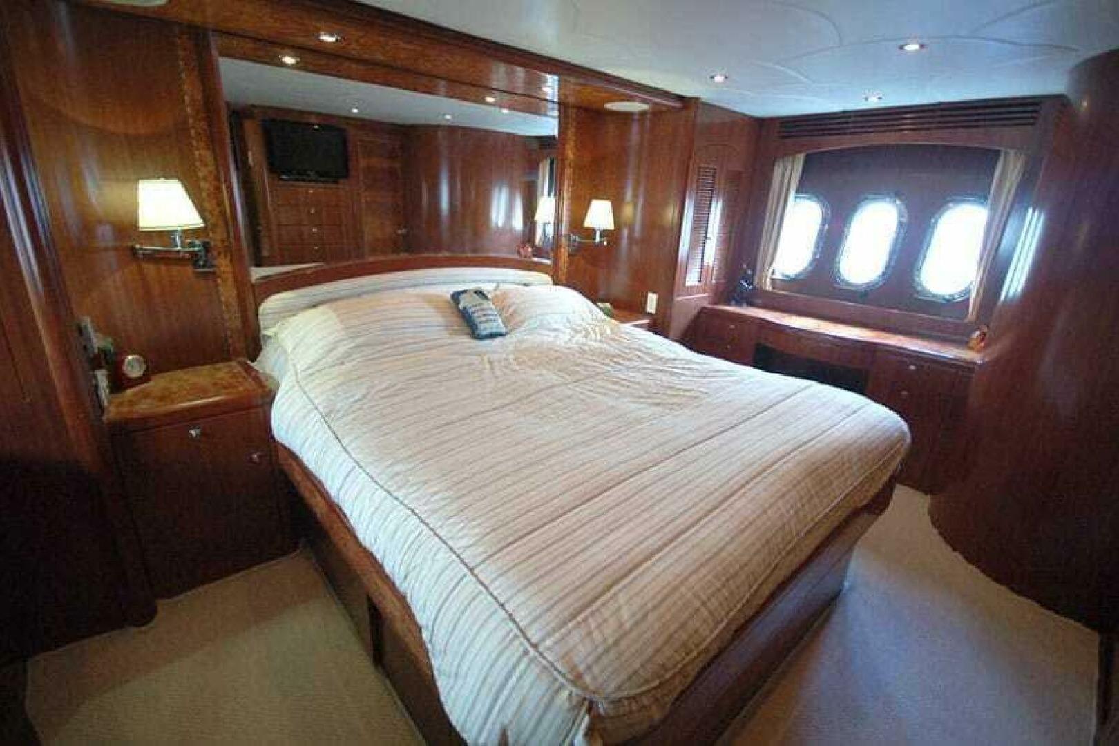 Luxurious bedroom in 2009 Grand Harbour 66 Motoryacht with elegant wood paneling.