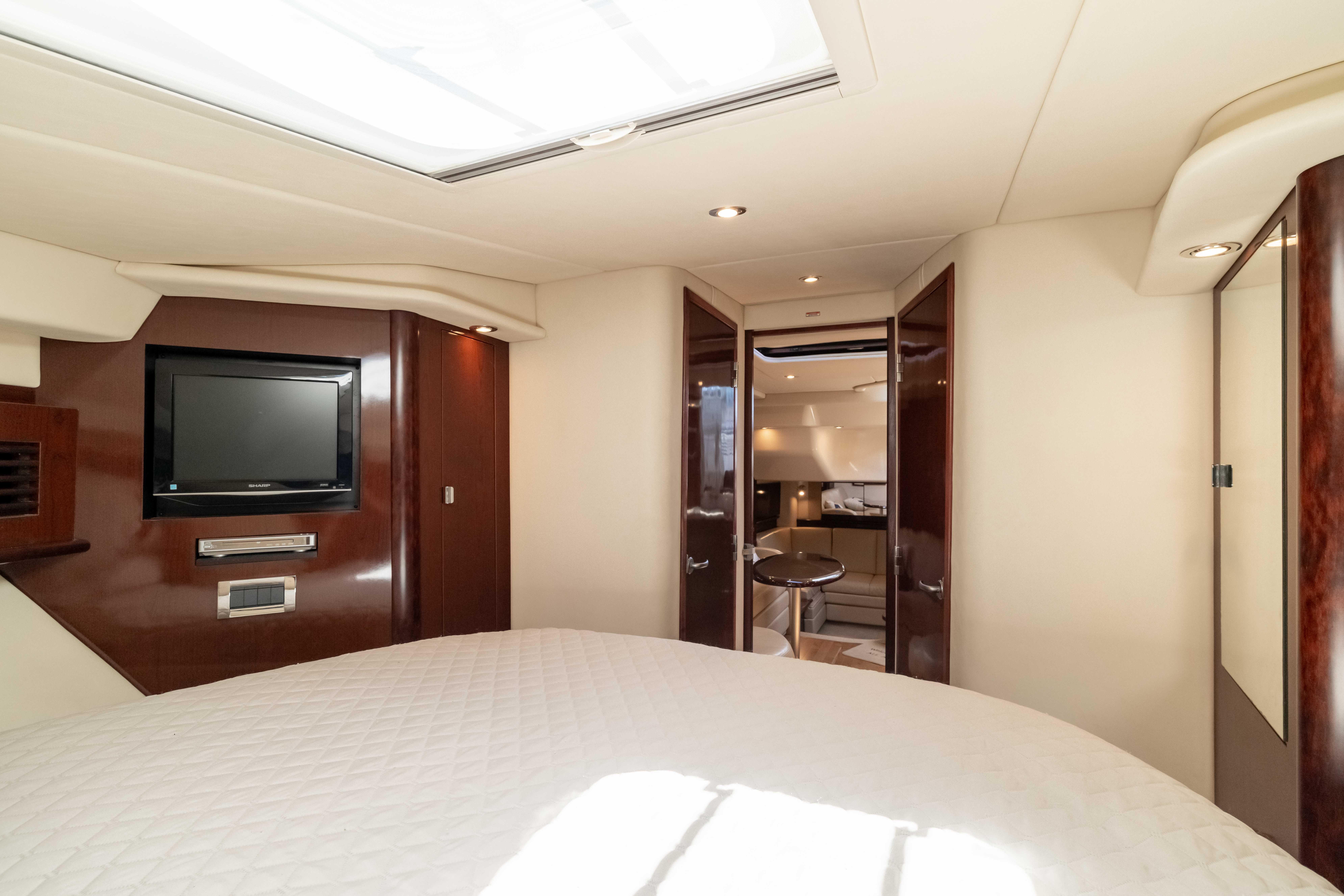 Luxurious interior of 2009 Sea Ray 40 Sundancer yacht with TV and elegant wood finishes.