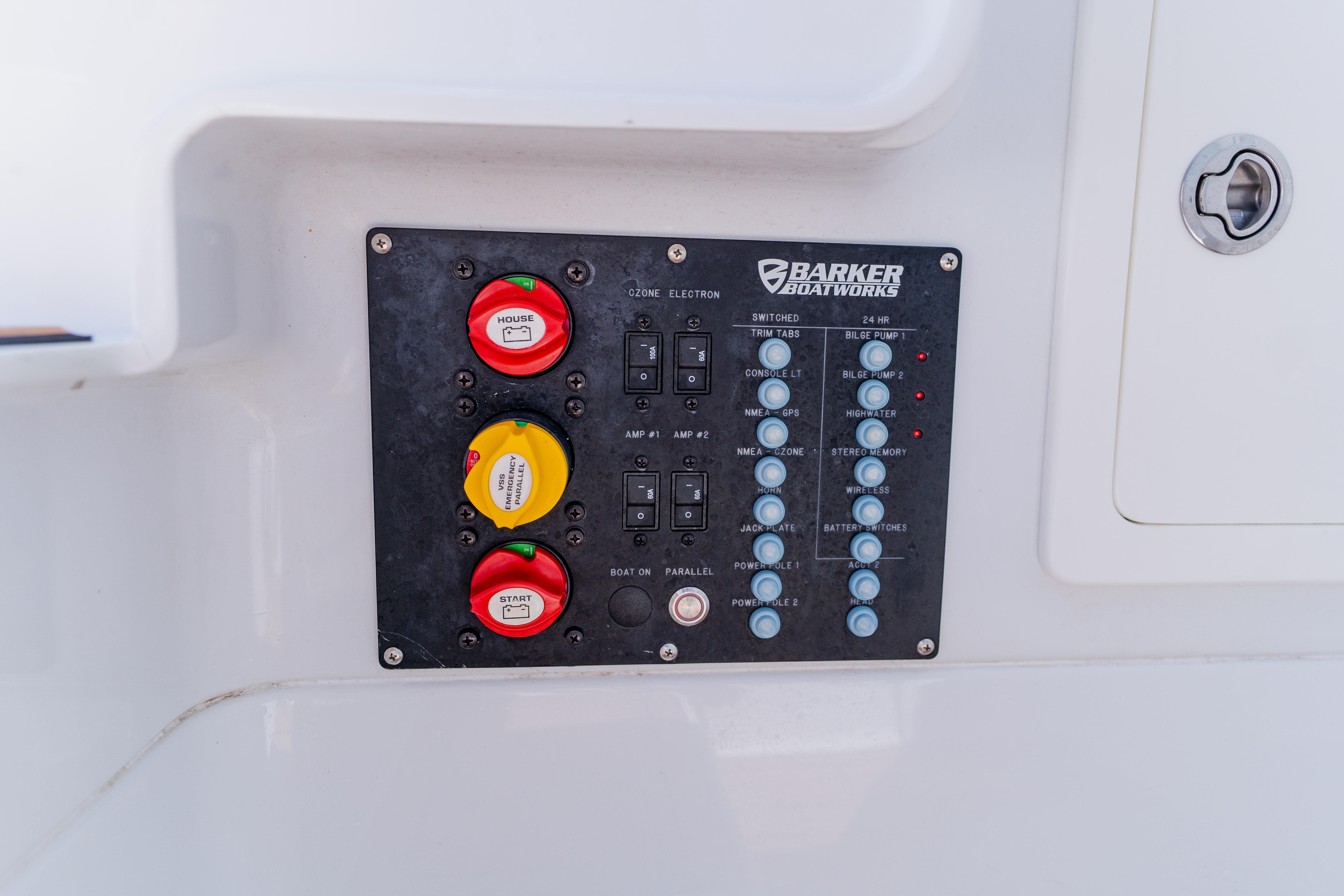Control panel of a 2017 Barker Boatworks 26, featuring switches and battery controls.