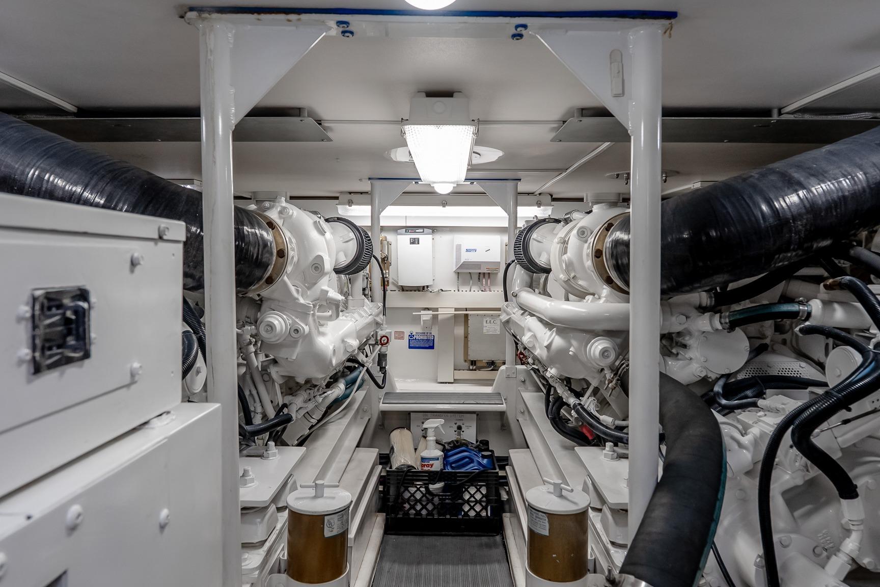 Engine room of a 2000 Viking 50' Convertible yacht, showcasing dual engines and mechanical systems.