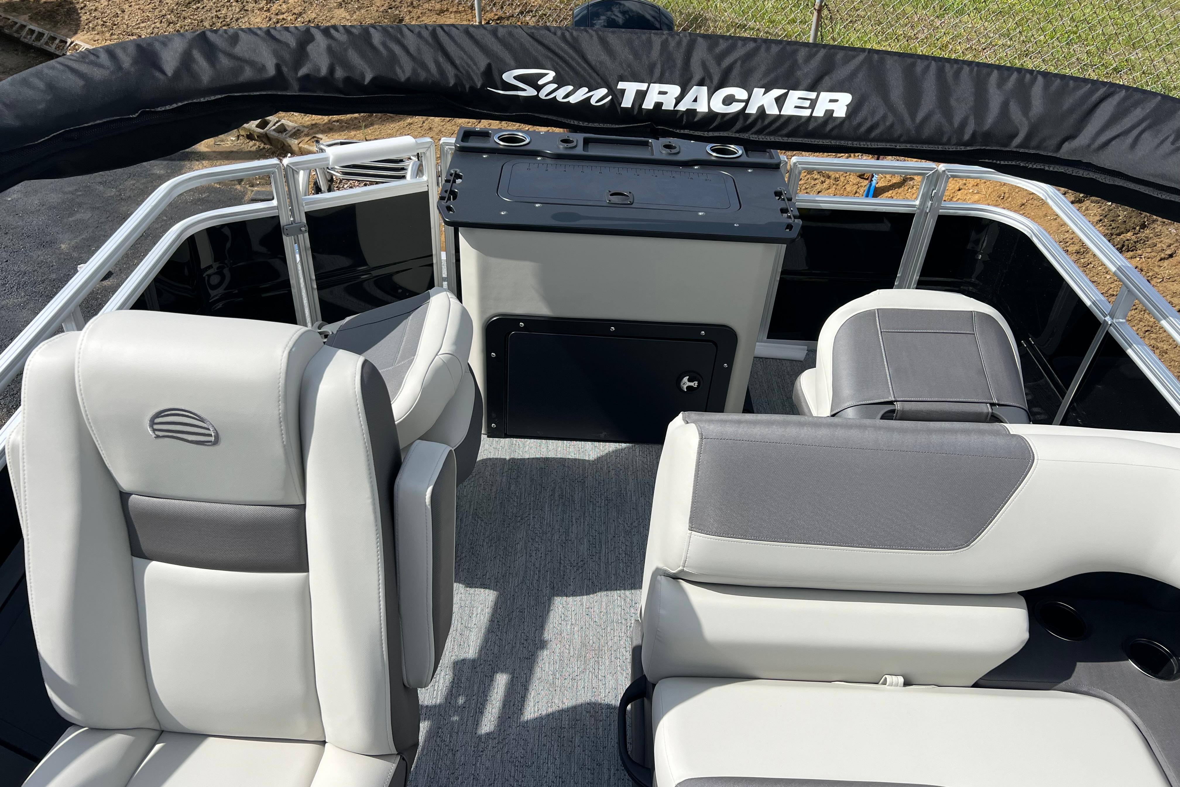 2026 Sun Tracker Fishin' Barge 22 DLX interior with comfortable seating and storage.