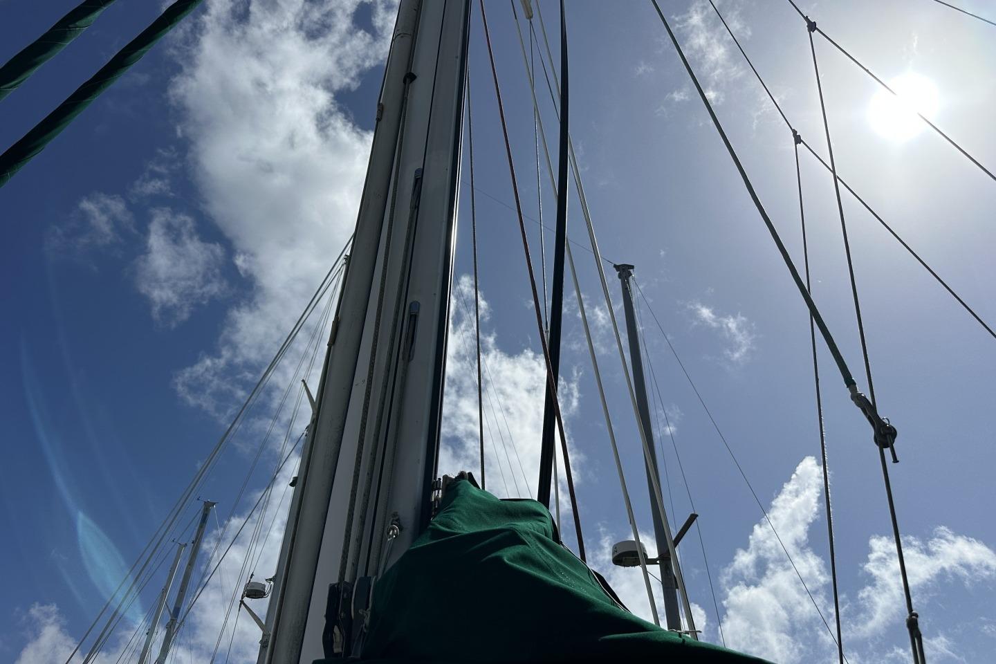 Sailboat mast and rigging against a bright sky, Valiant 40, 1976 model.