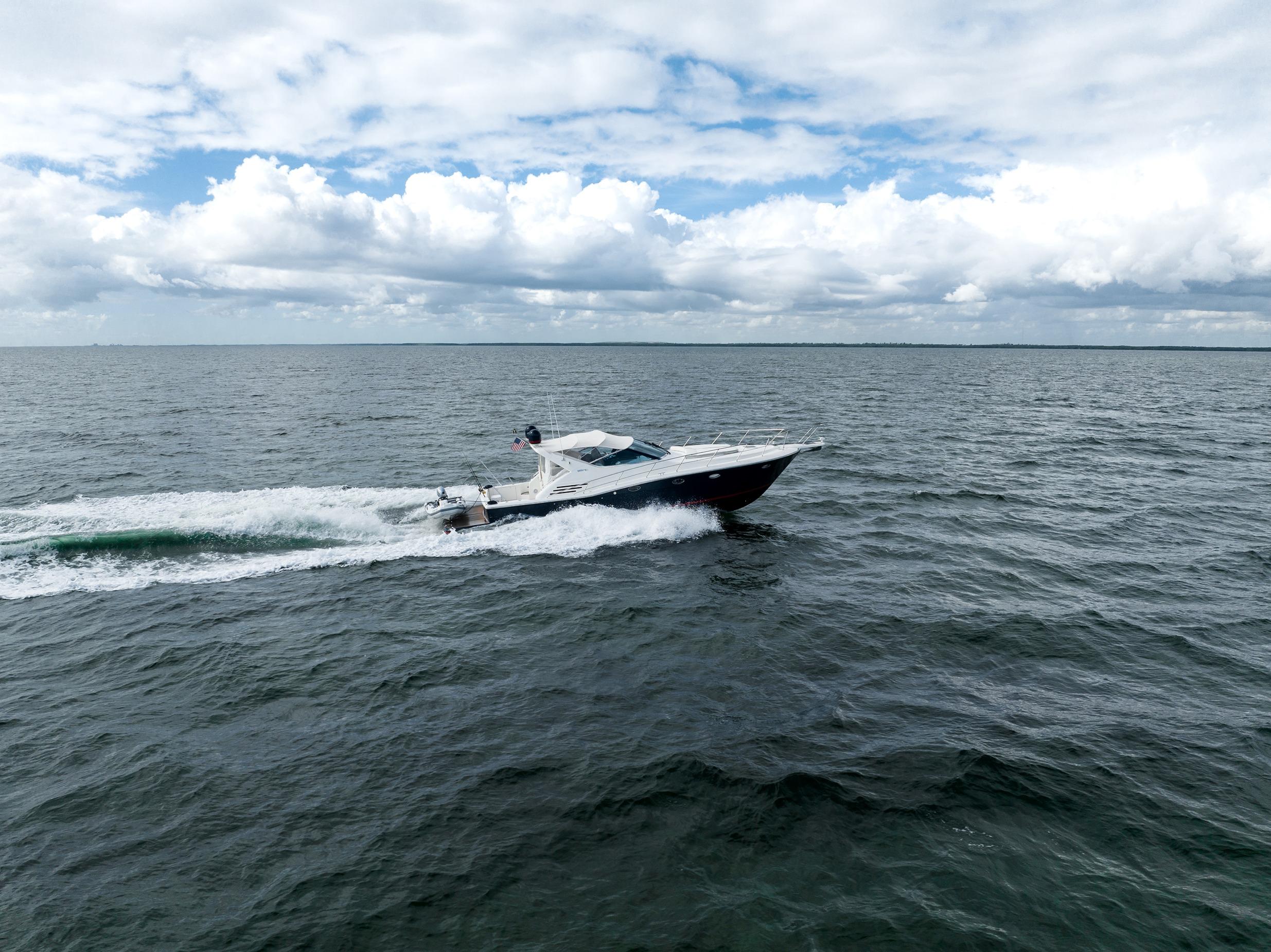 Uniesse 48 Open 2001 yacht cruising on open sea under cloudy sky.