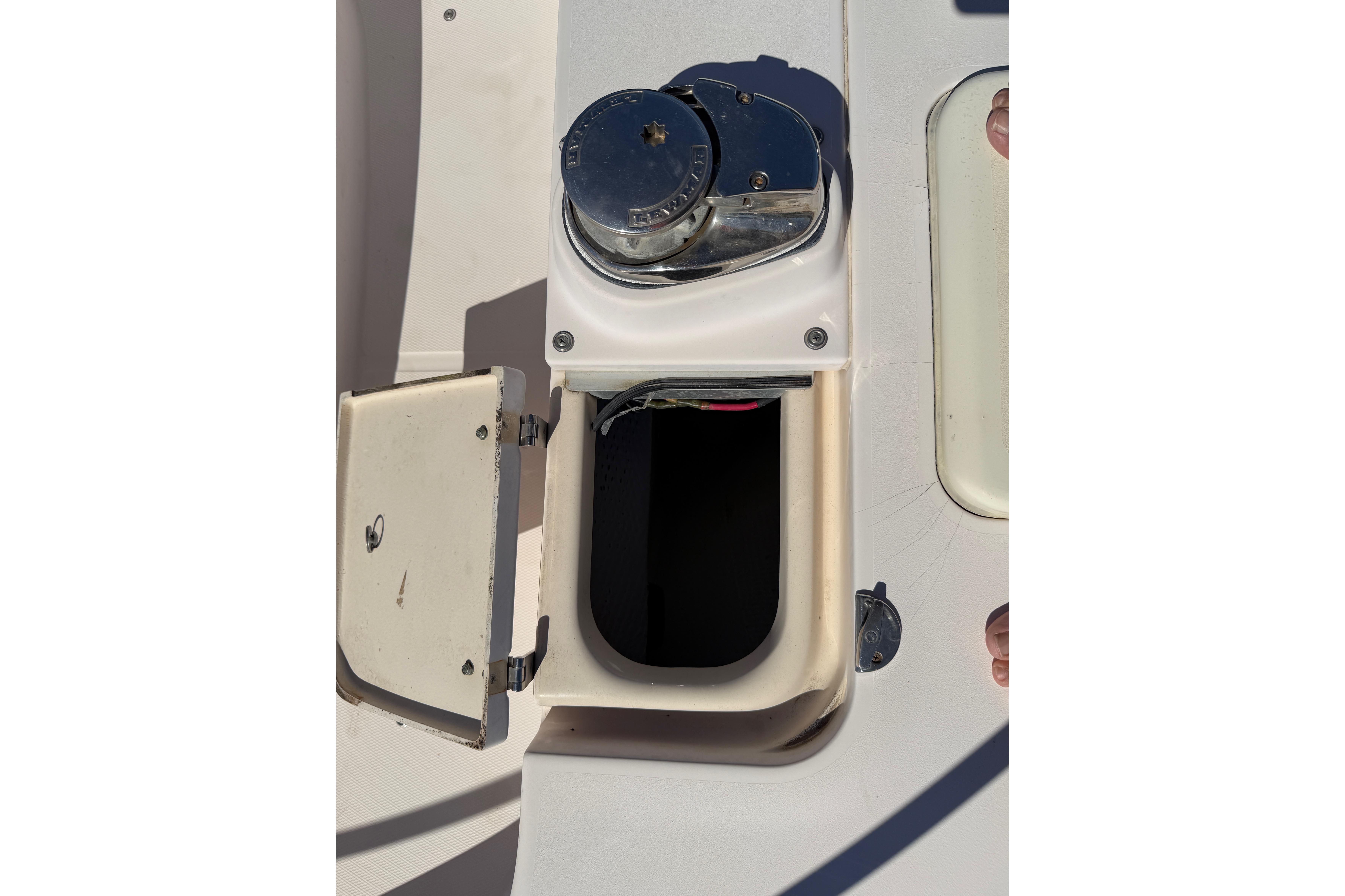 Open hatch on 2006 Grady-White Sailfish 282 boat deck, showing storage compartment.