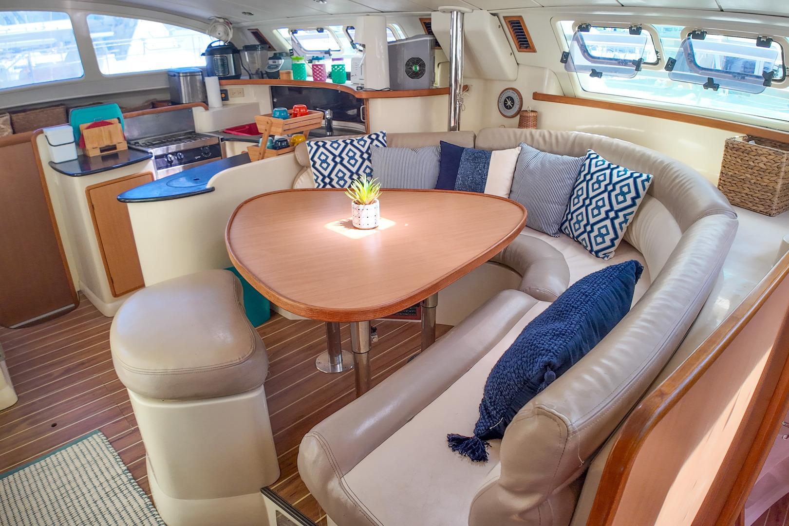 Luxurious interior of 2005 Leopard 43 yacht with cozy seating and modern kitchen.