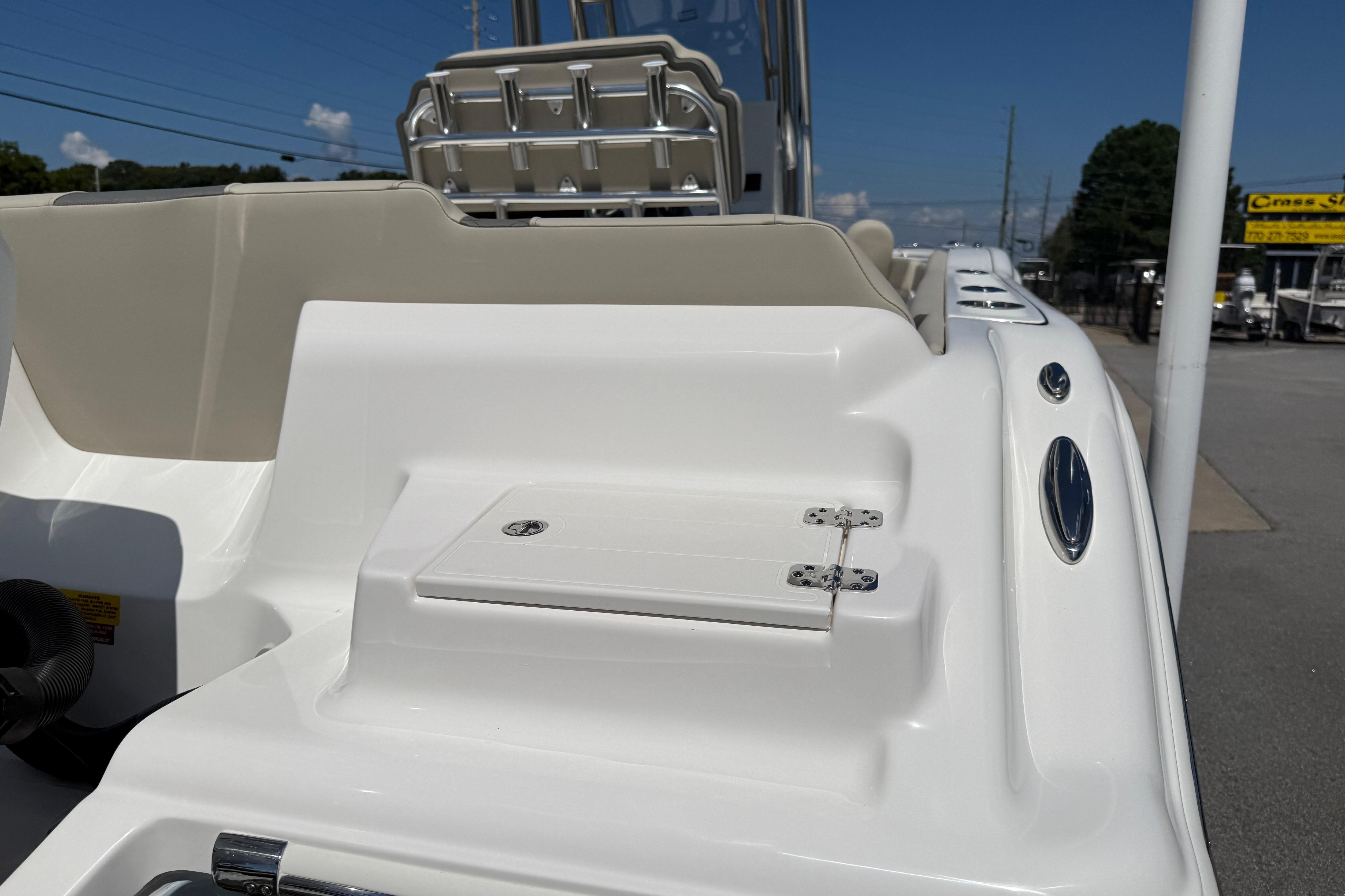 2026 Key West 239 FS boat deck with seating and storage compartment.