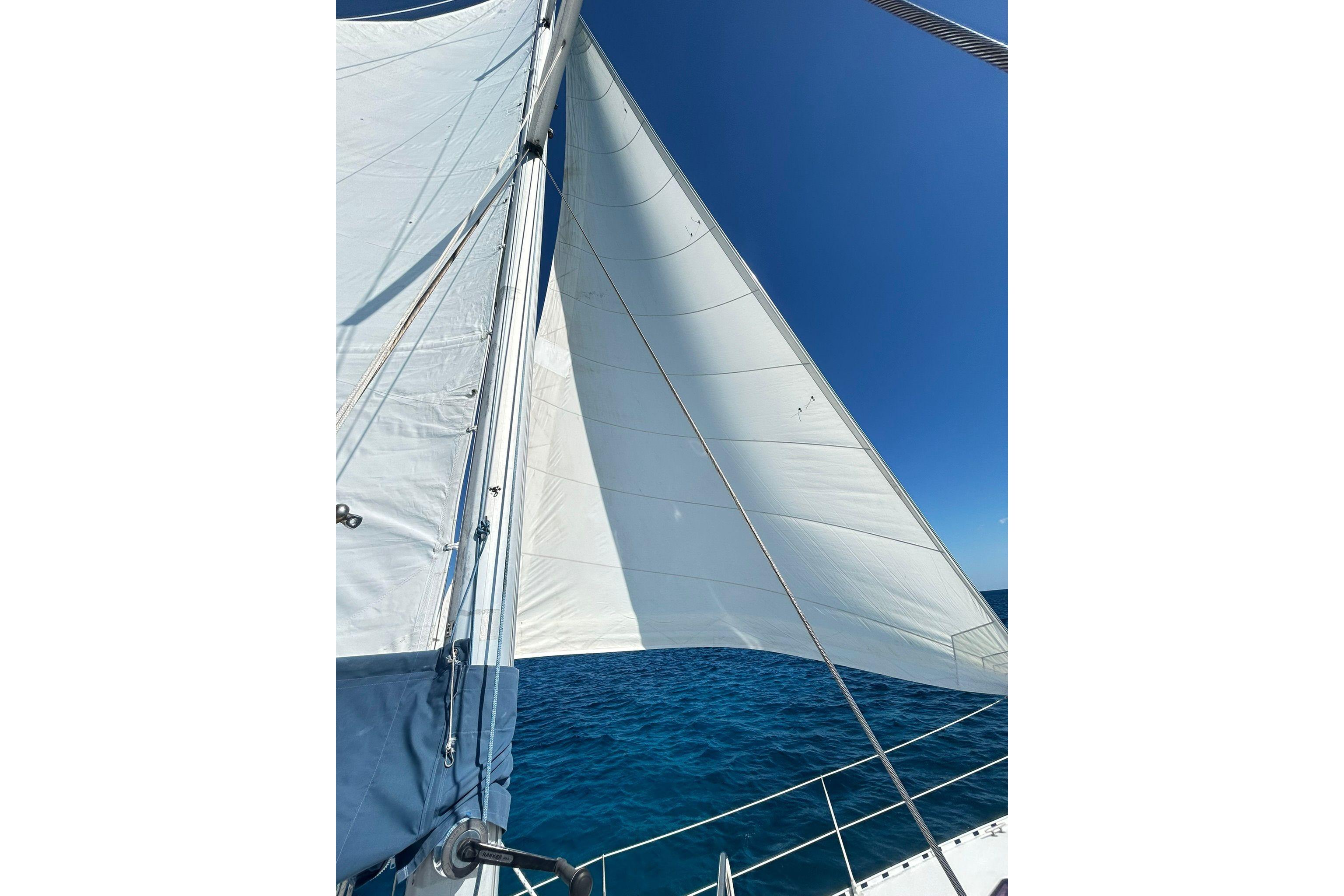 Sailing on a 1987 Gulfstar CSY 50 Pilot House under clear blue skies.