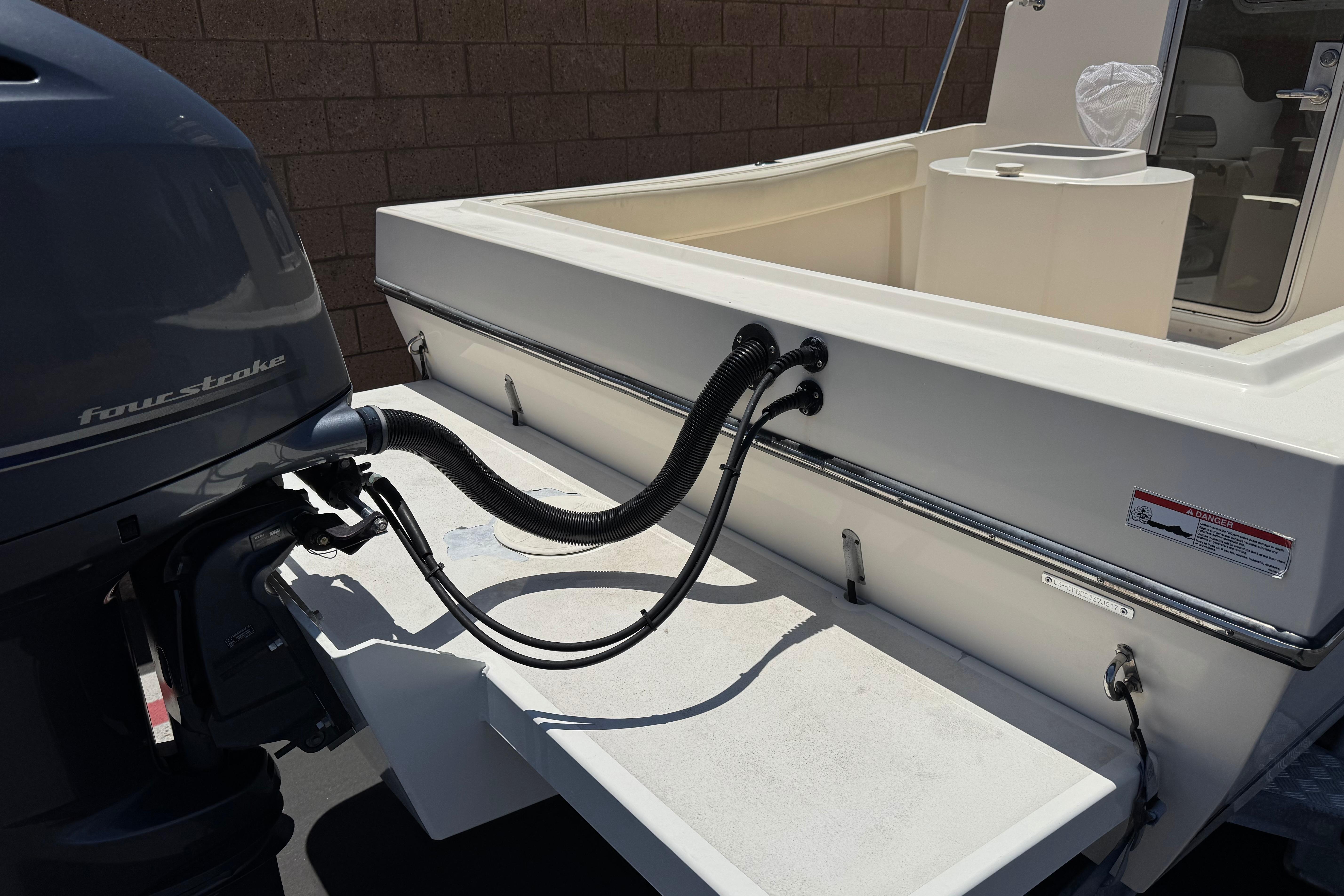 2017 Defiance Admiral 220 EX boat with four-stroke engine, rear view.