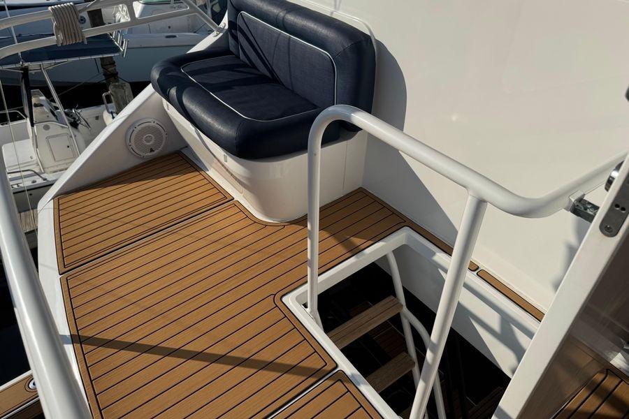 2002 Viking 61 Enclosed Bridge yacht deck with seating and stairs.