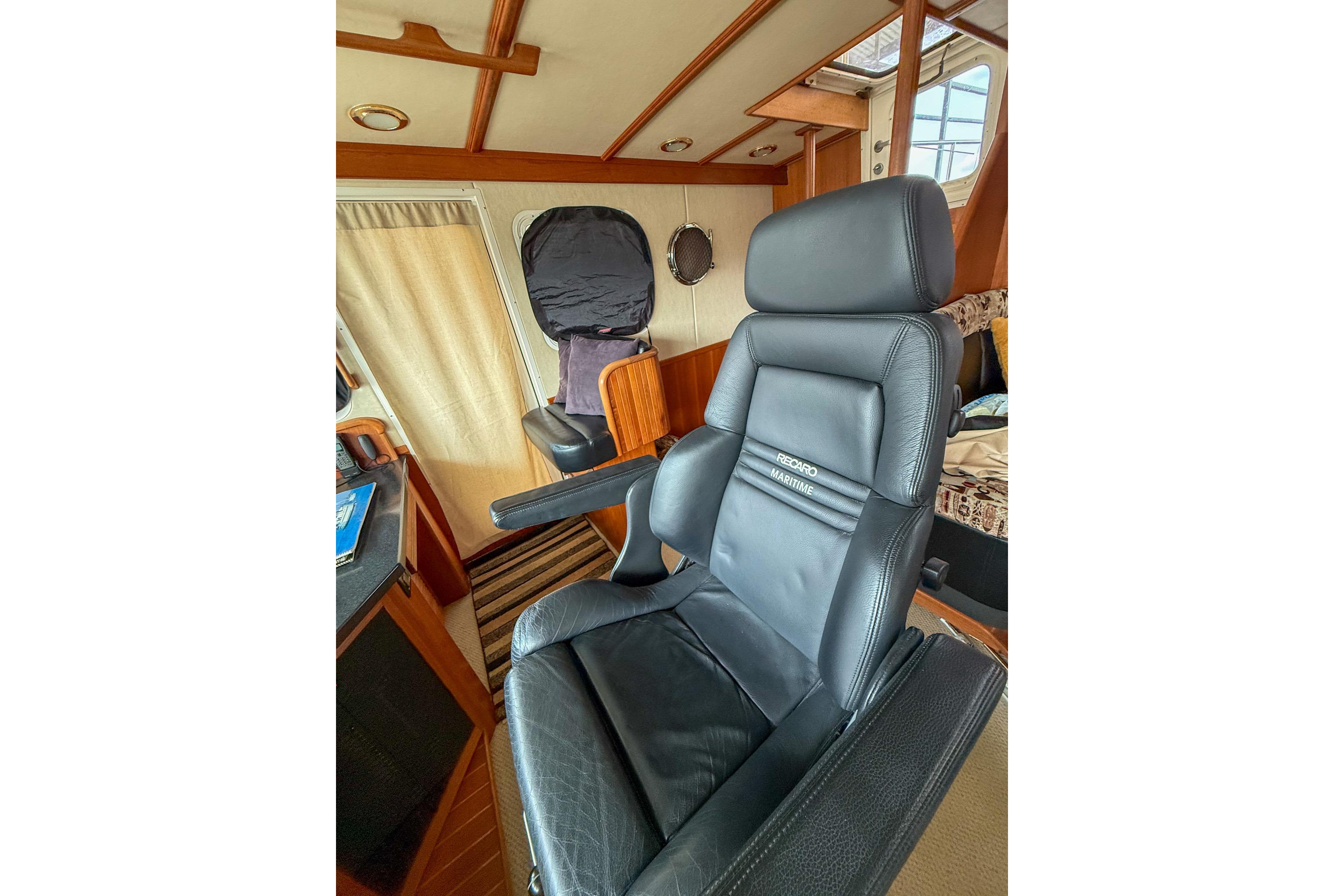 Luxurious black leather captain's chair in 2007 Nordic Tug 54 interior.