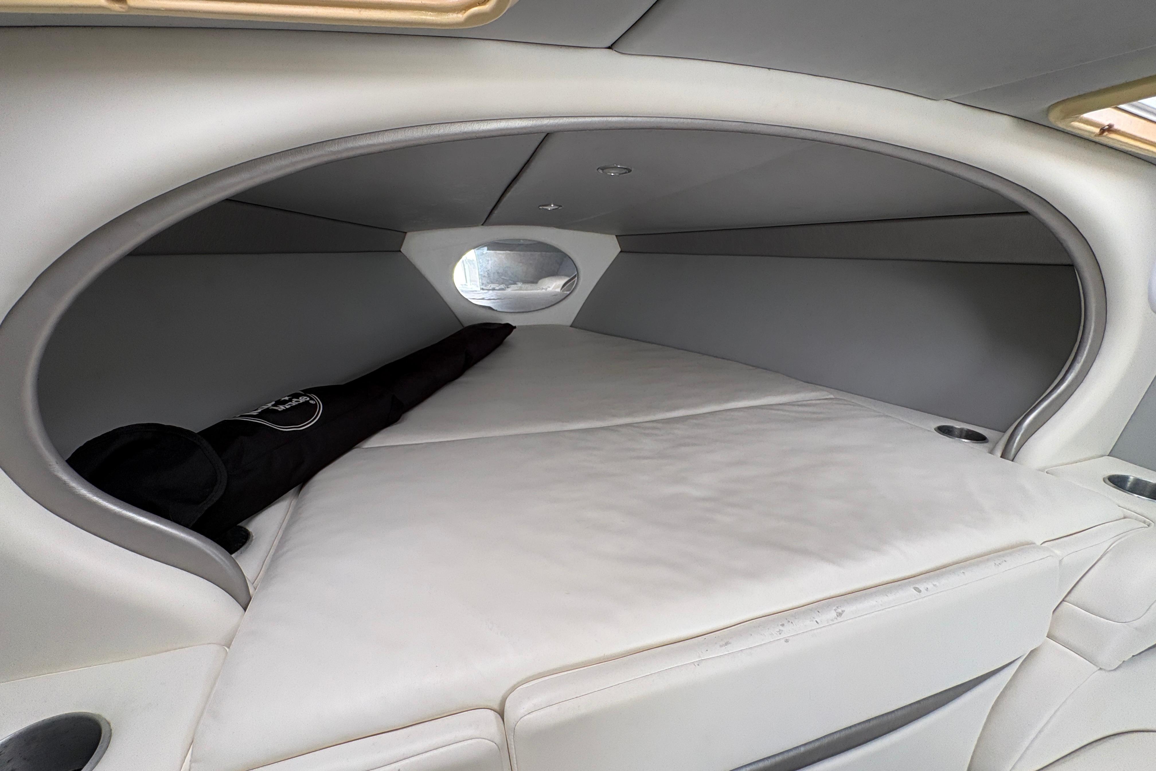 Interior cabin of a 2002 Formula 292 FASTech boat, featuring a cozy sleeping area.