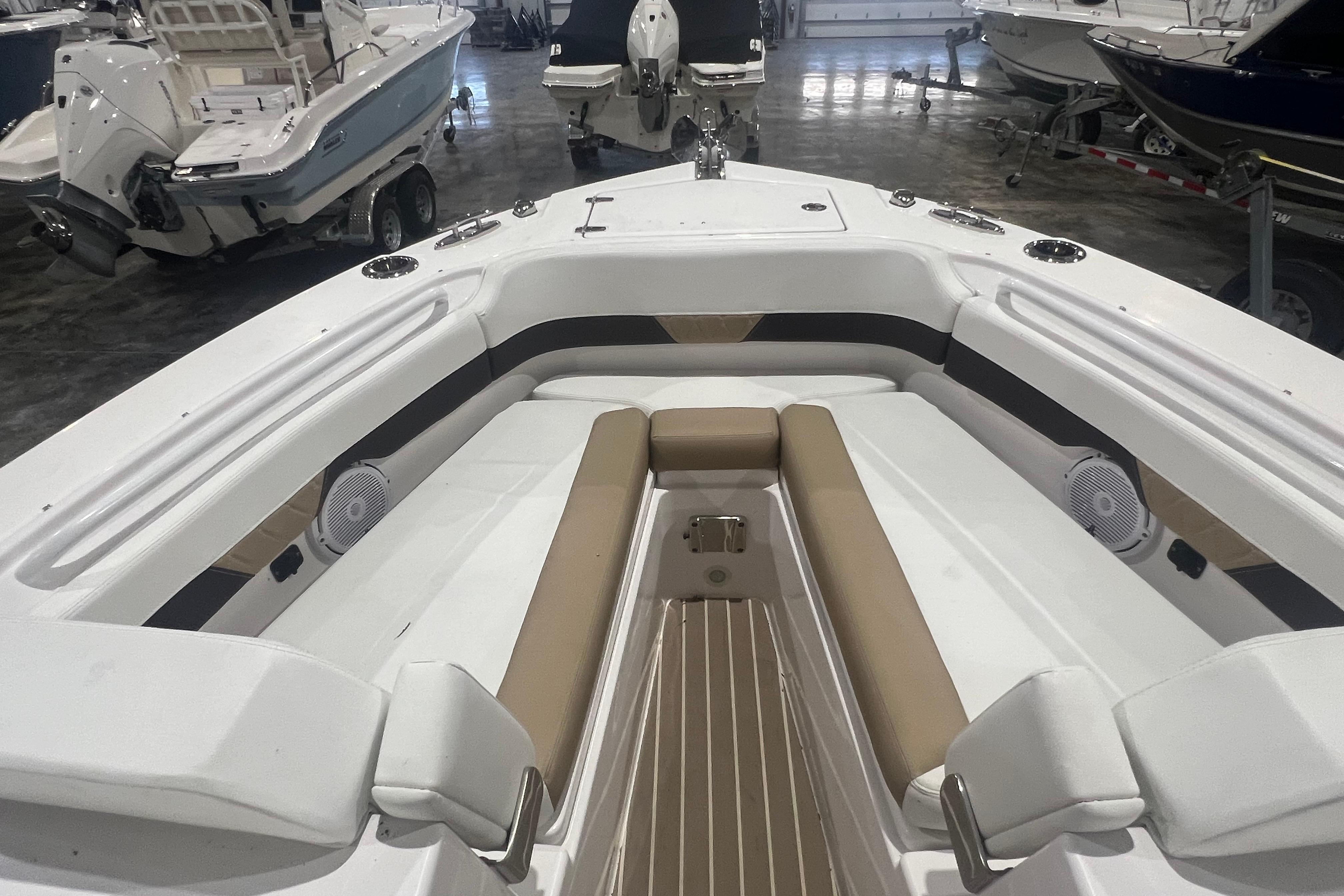 2023 Edgewater 230CX Crossover boat interior with cushioned seating and speakers.