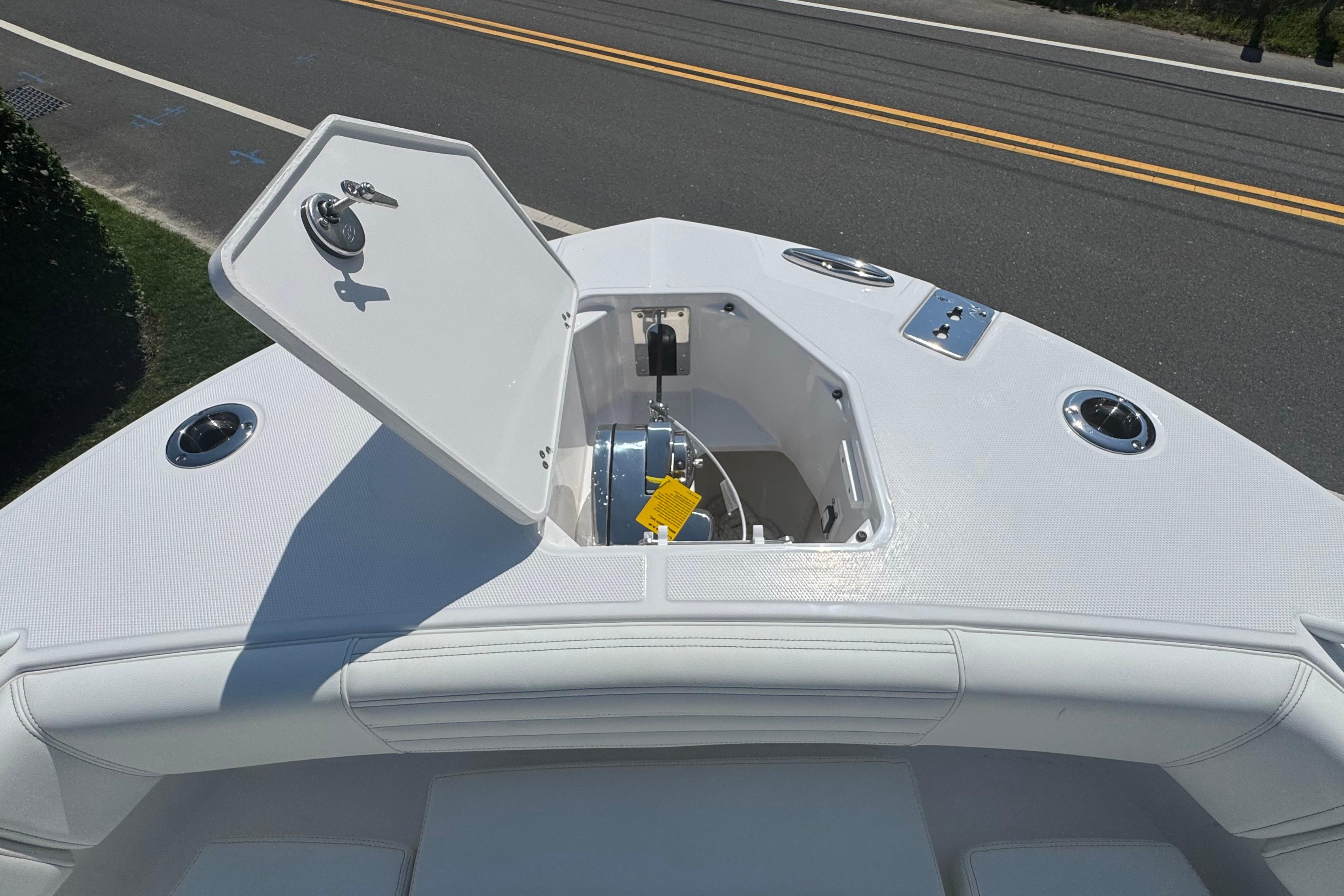 2026 Edgewater 250CC boat anchor compartment with open hatch, showcasing sleek design.