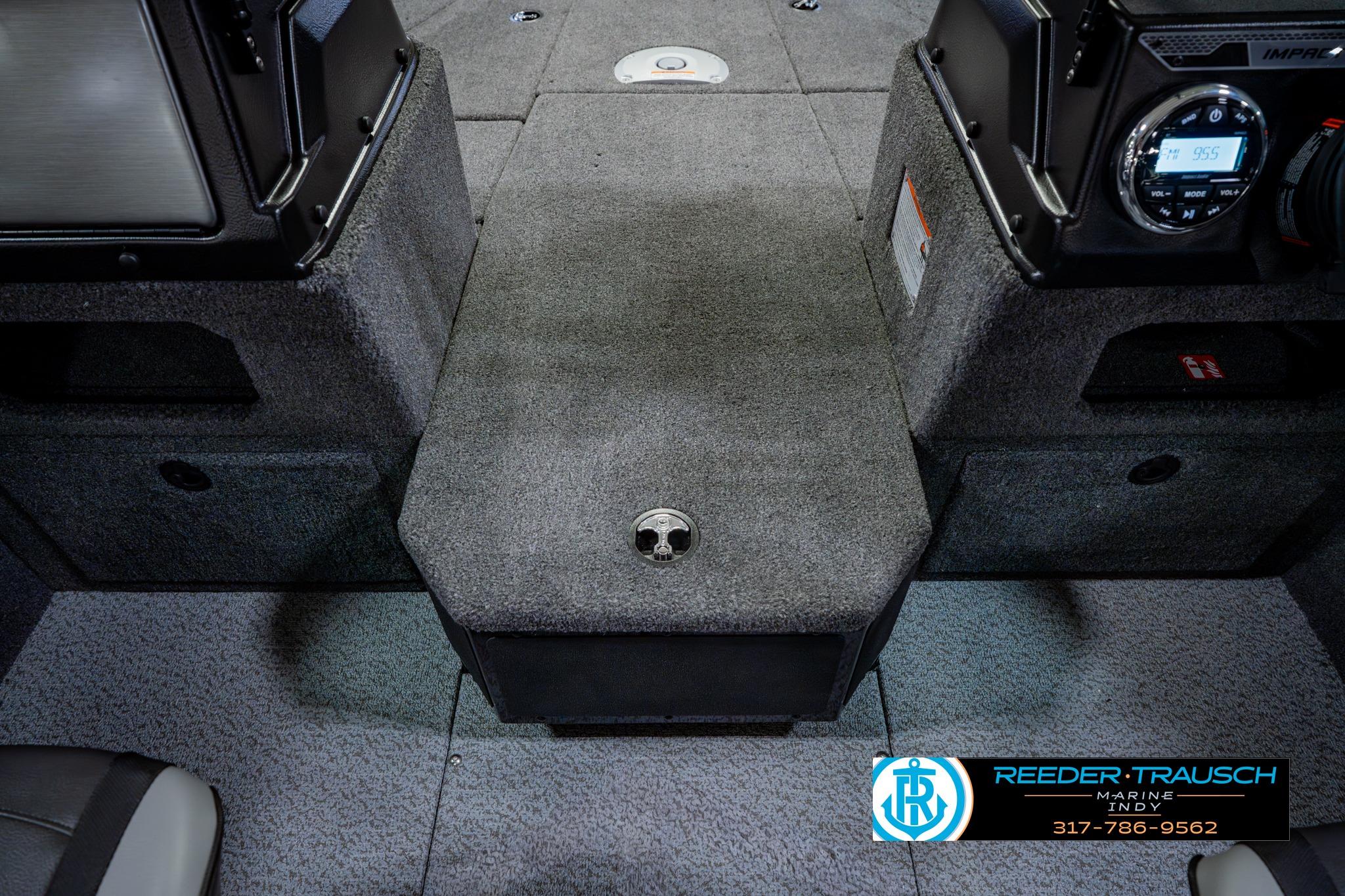 2026 Lund 1875 Impact XS boat interior with carpeted flooring and control panel.