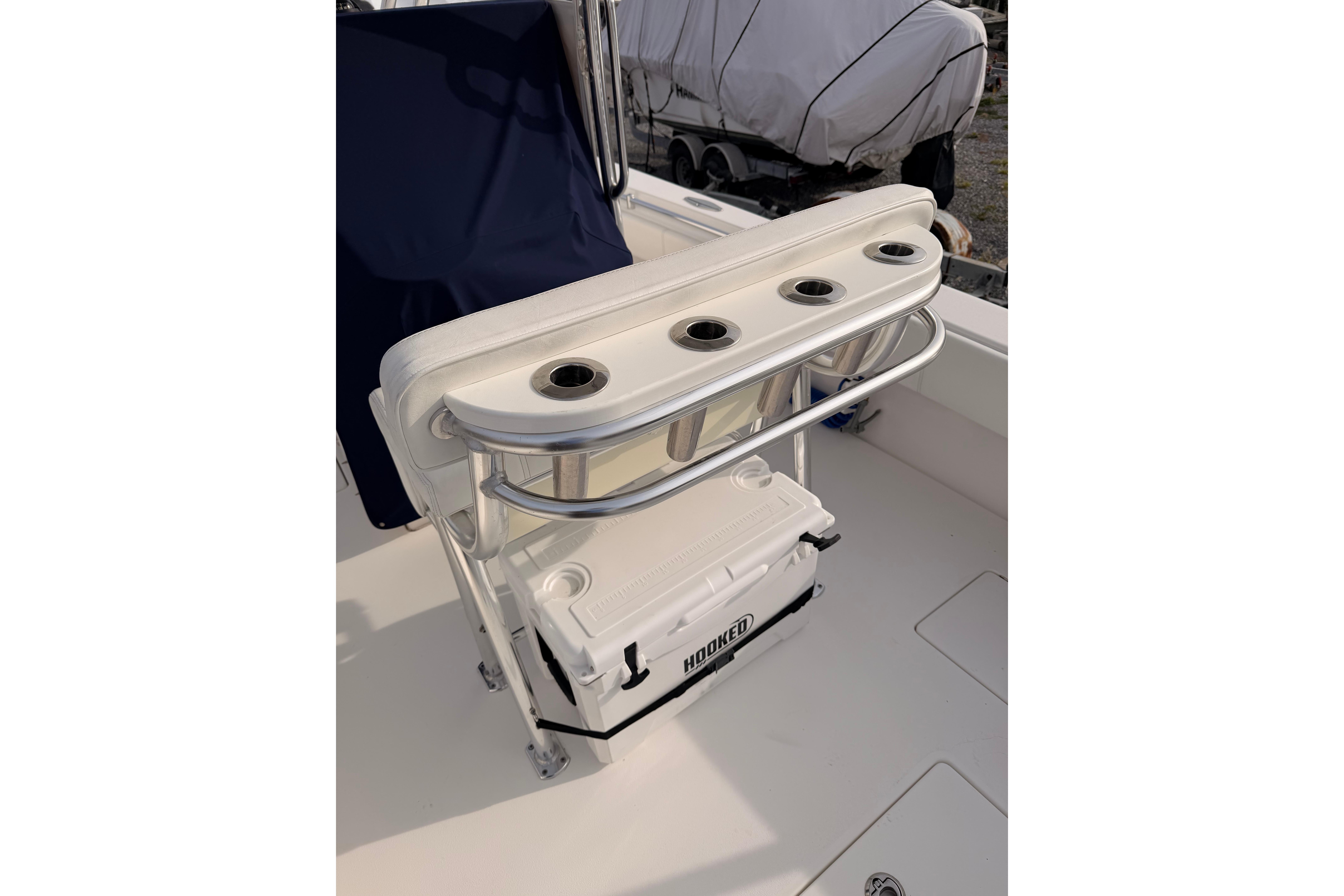 Boat seating with rod holders and cooler on Contender vessel.