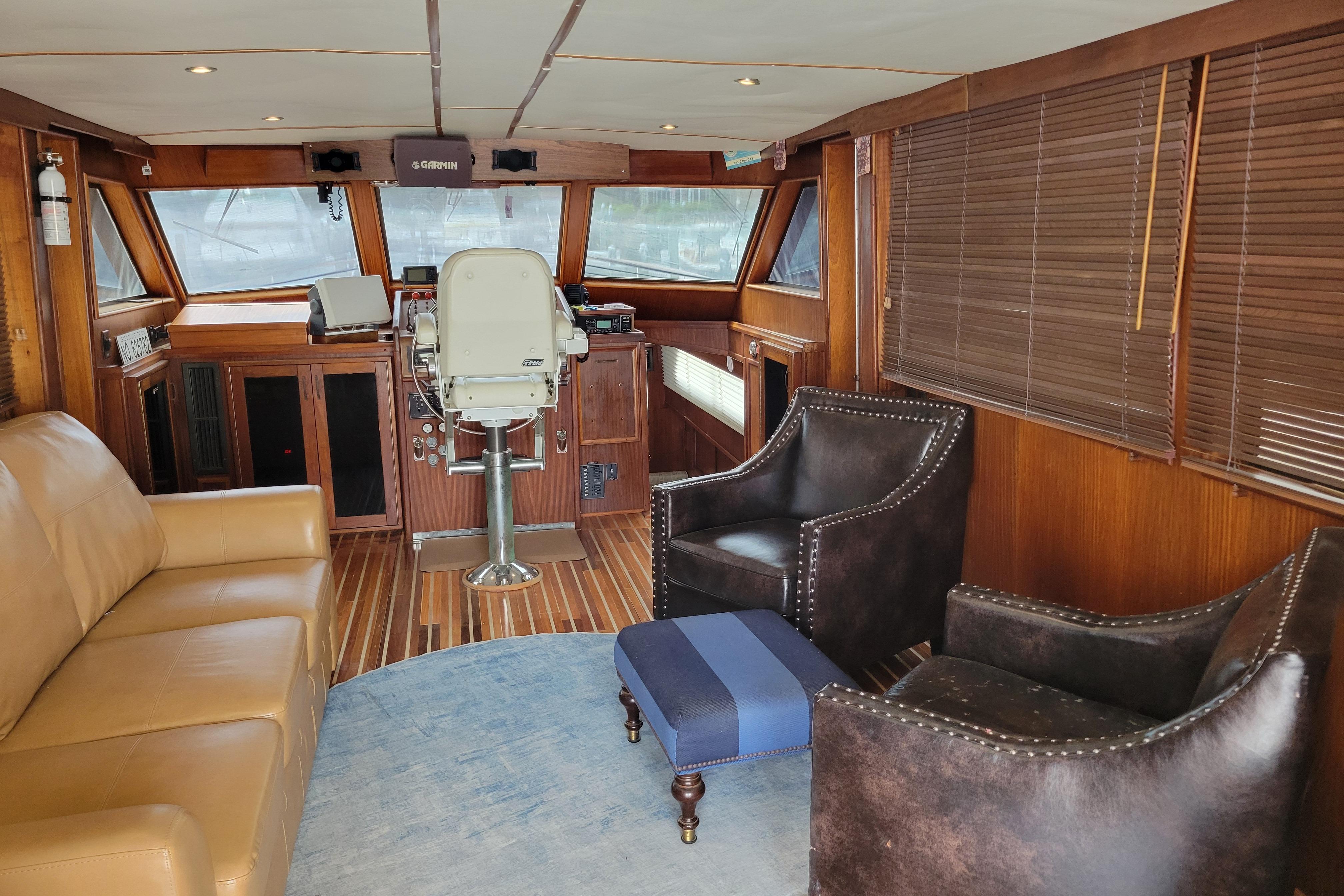 Interior of a 1980 Hatteras 53 Yacht Fisherman with leather seating and wooden accents.